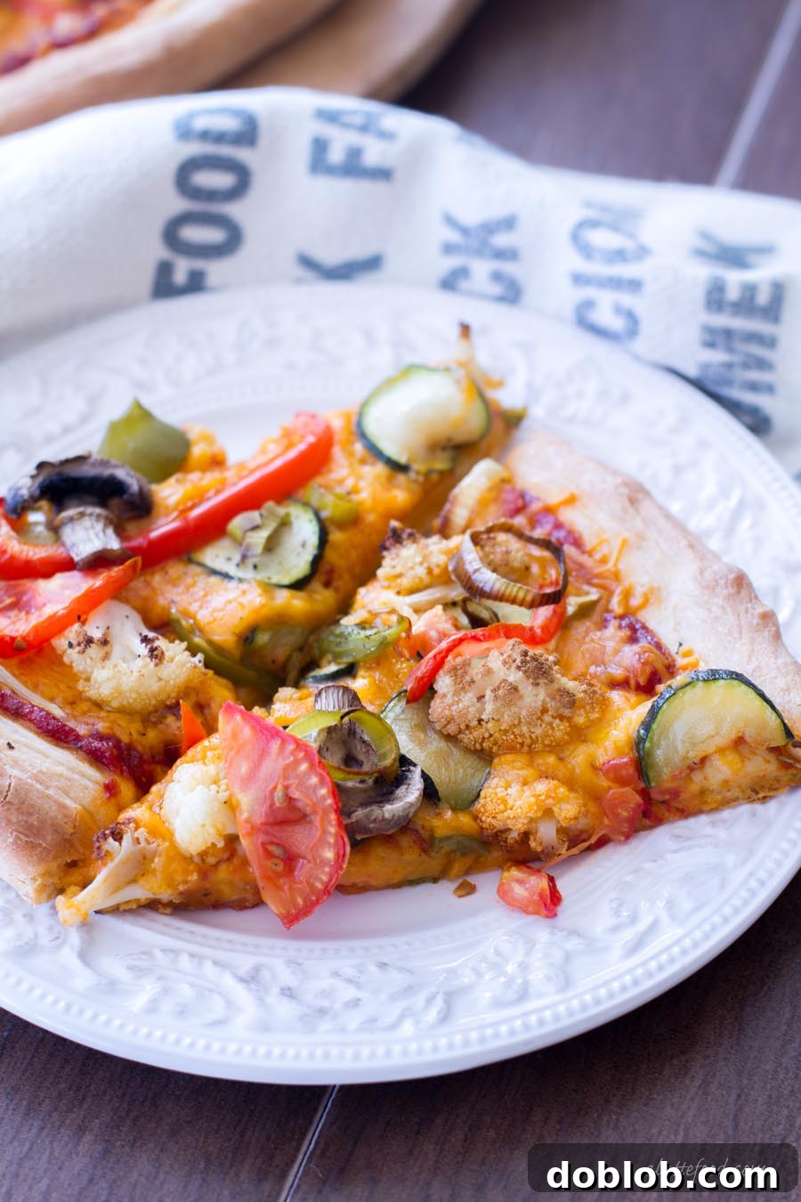 Close-up of a bubbling, cheesy Roasted Vegetable Pizza