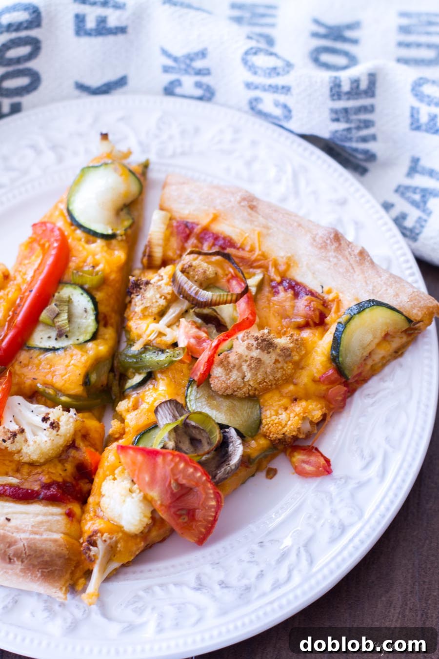 A slice of delicious Roasted Vegetable Pizza being served