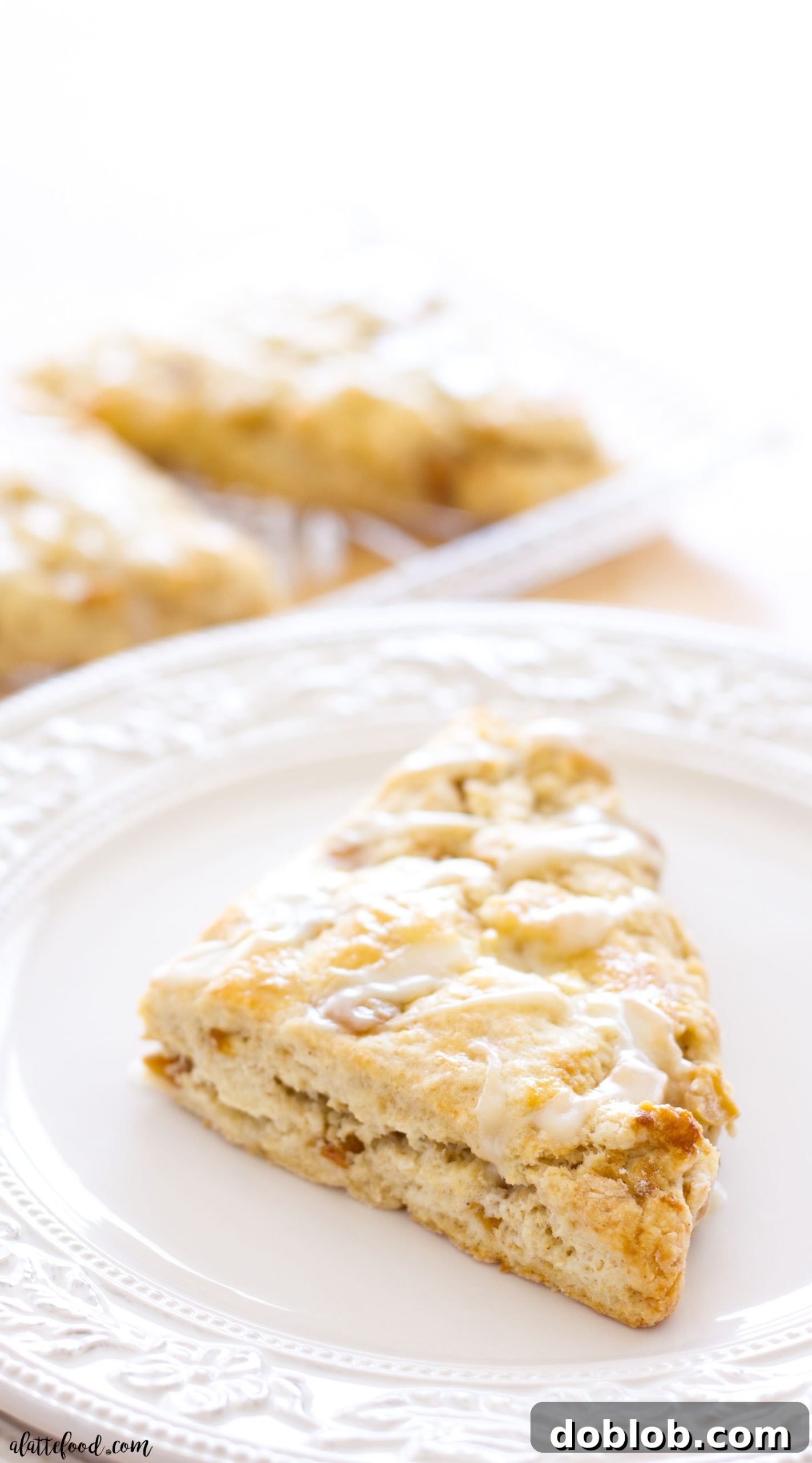 Light, flaky homemade apple pie scones topped with a subtle maple glaze, perfect for breakfast, brunch, or an afternoon treat.