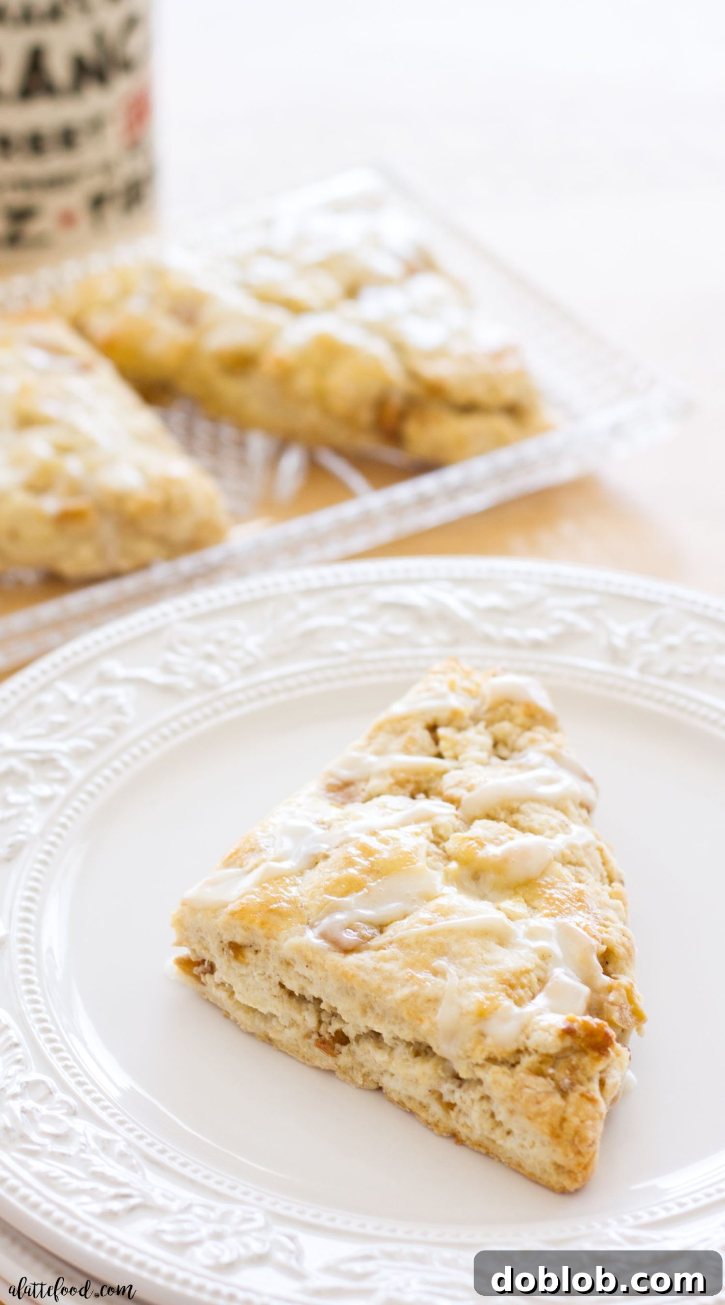 Delicious apple pie scones, showcasing their flaky texture and apple filling, drizzled with maple glaze.