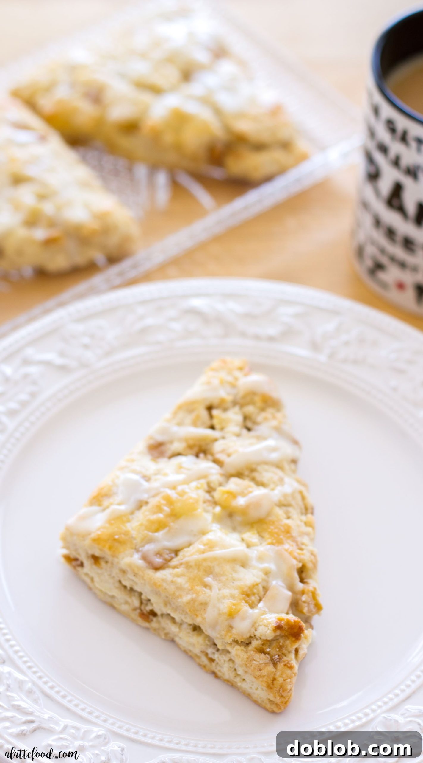Close-up of freshly baked apple pie scones with maple glaze, highlighting their golden-brown finish.