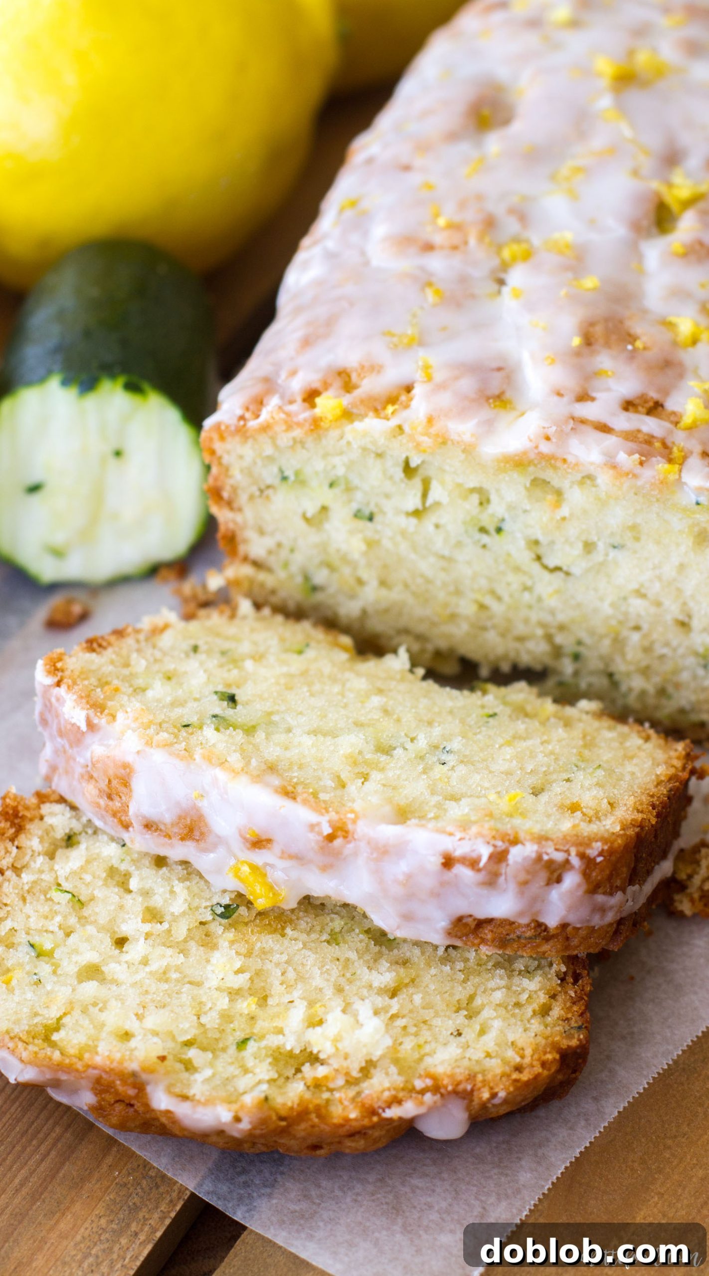 A whole loaf of Lemon Zucchini Bread, freshly baked and glazed, sitting on a wire cooling rack.