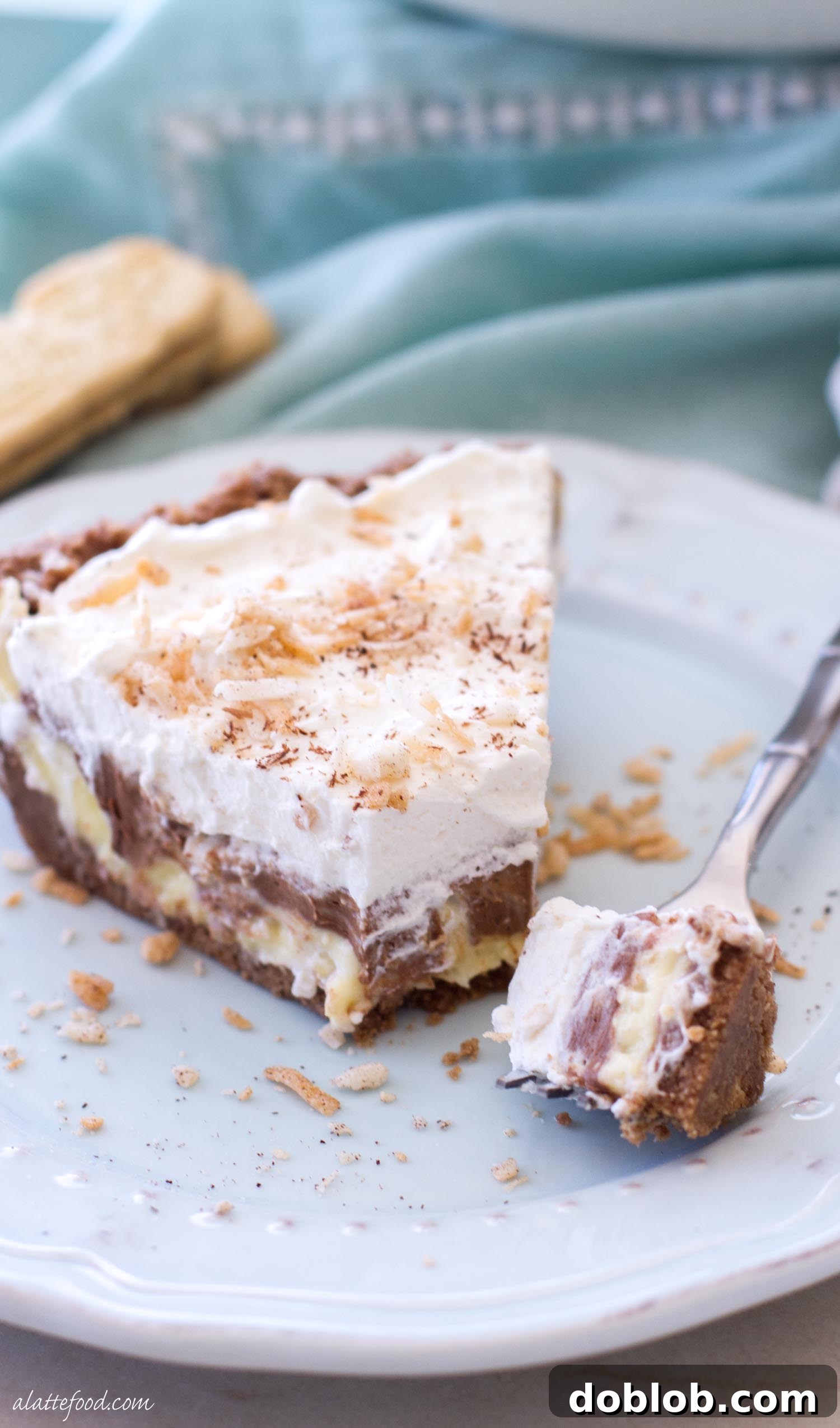 A perfectly portioned slice of no-bake chocolate coconut cream pie, showcasing its rich layers.