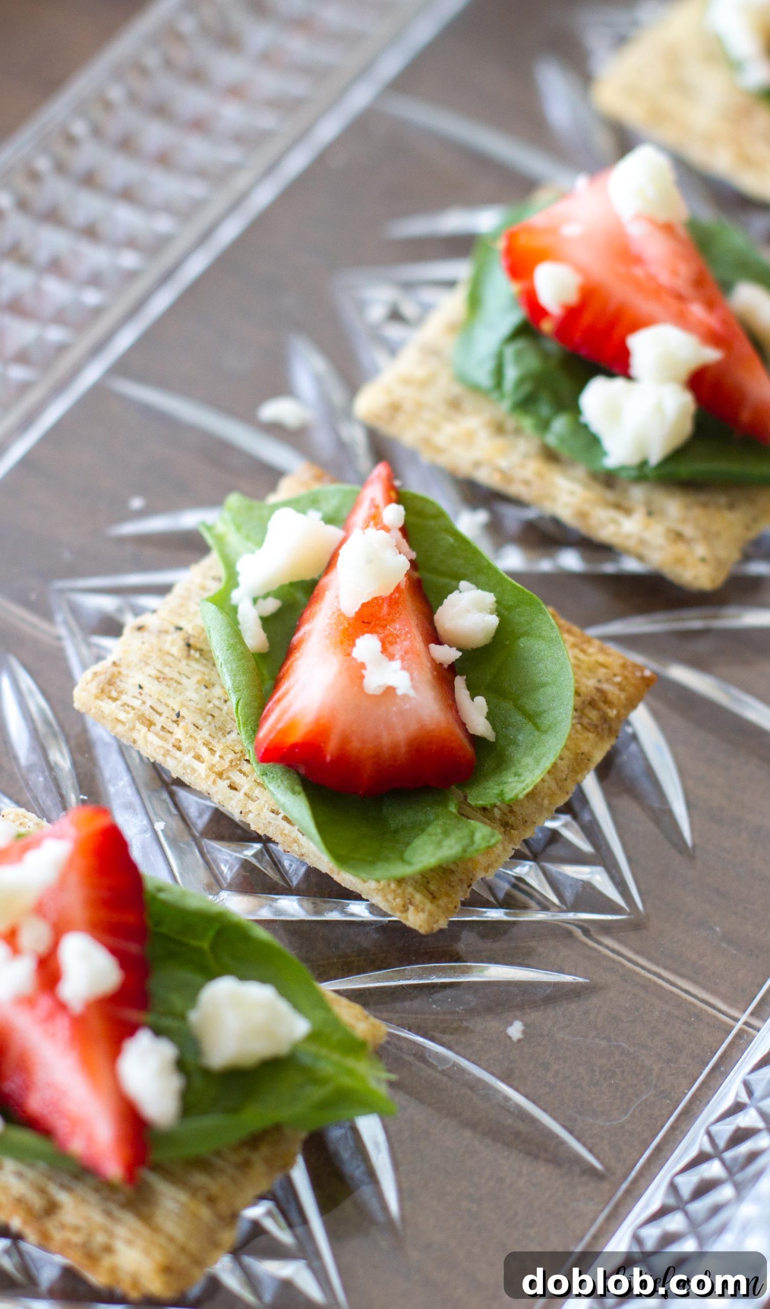 A perfectly plated Spinach, Strawberry, and Feta TRISCUIT cracker, ready to be enjoyed as a gourmet snack.