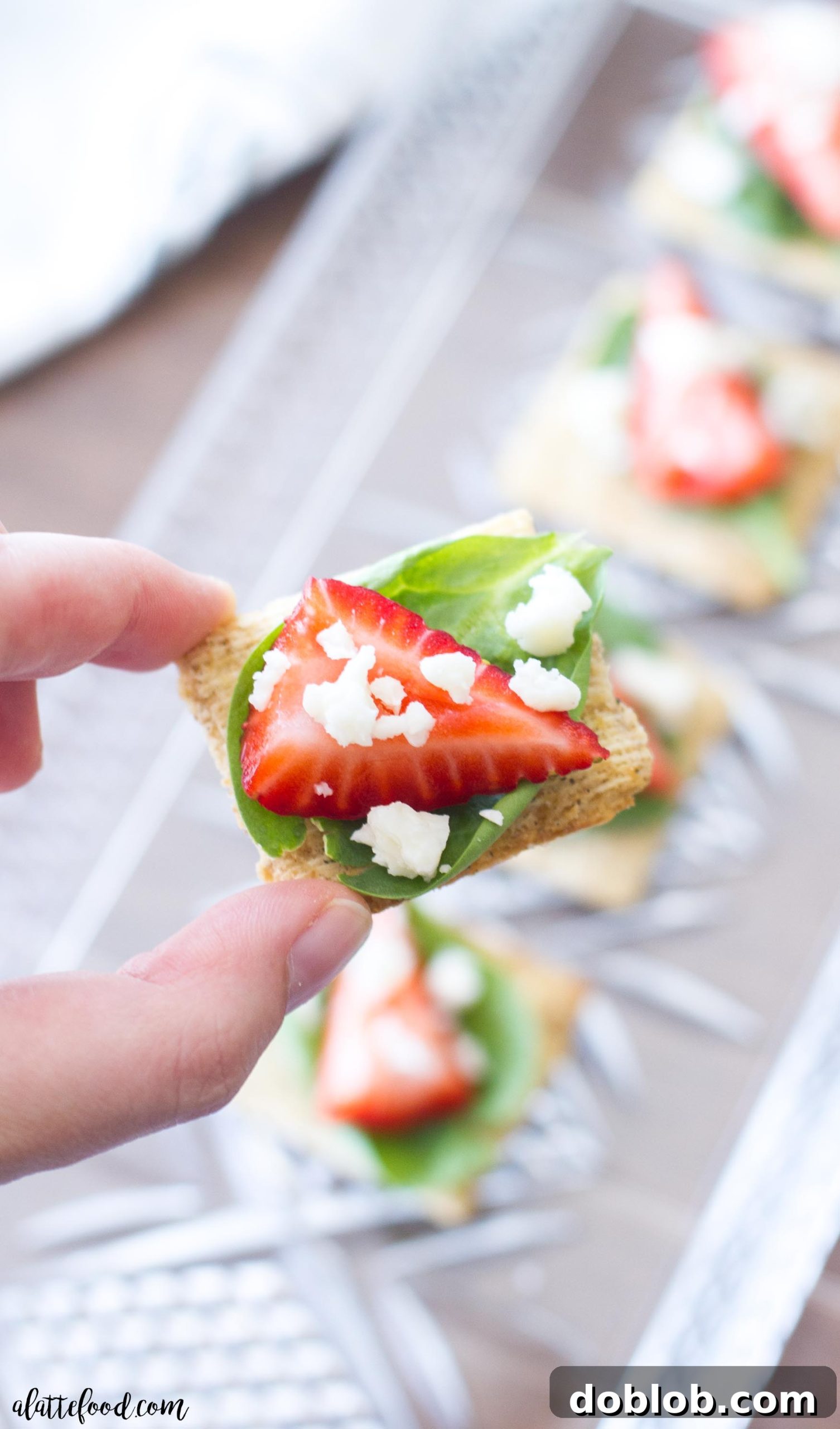 A high-angle shot of a platter filled with freshly made Spinach, Strawberry, and Feta TRISCUIT appetizers, ready for guests.