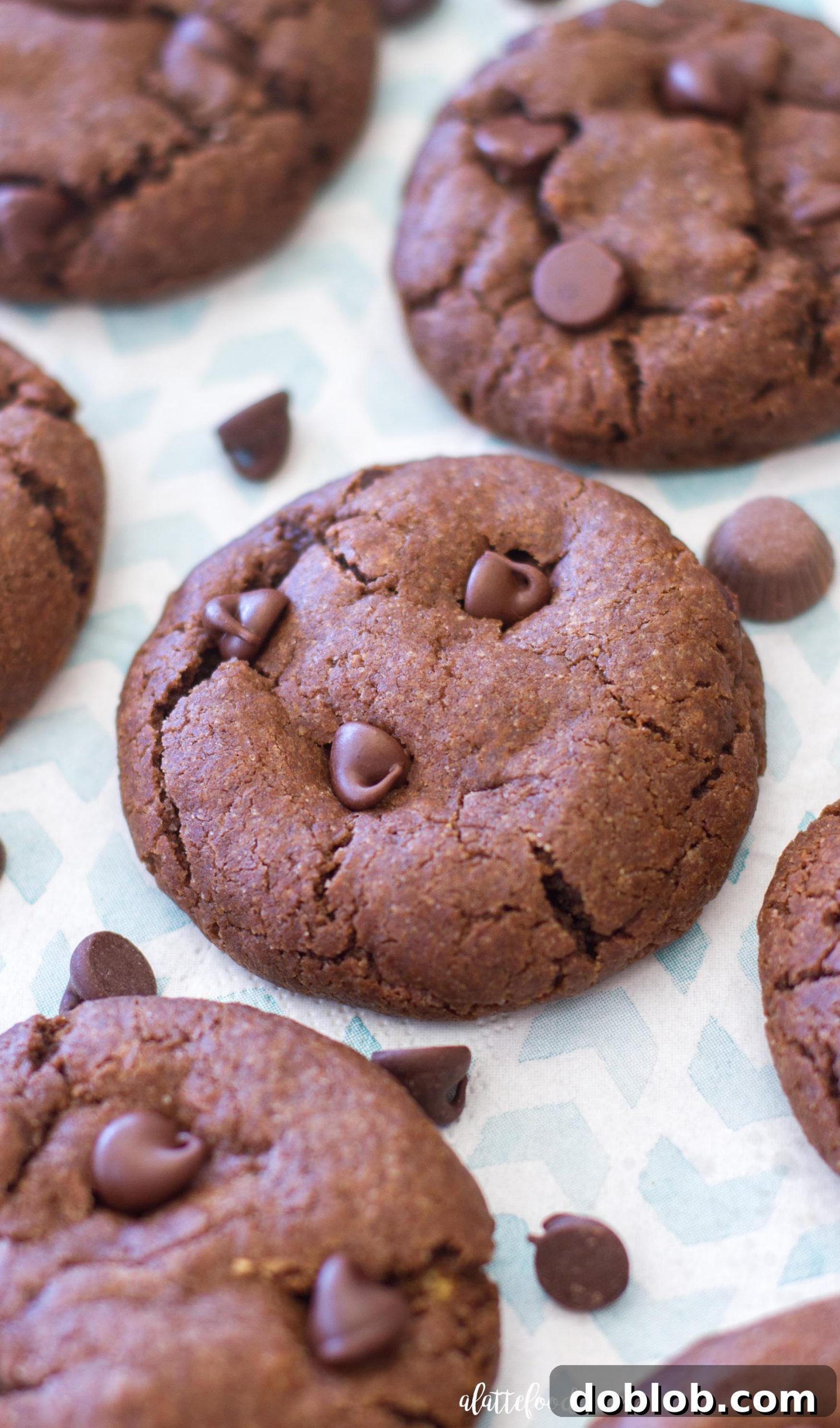 A stack of delicious double chocolate peanut butter caramel cookies with melted caramel visible