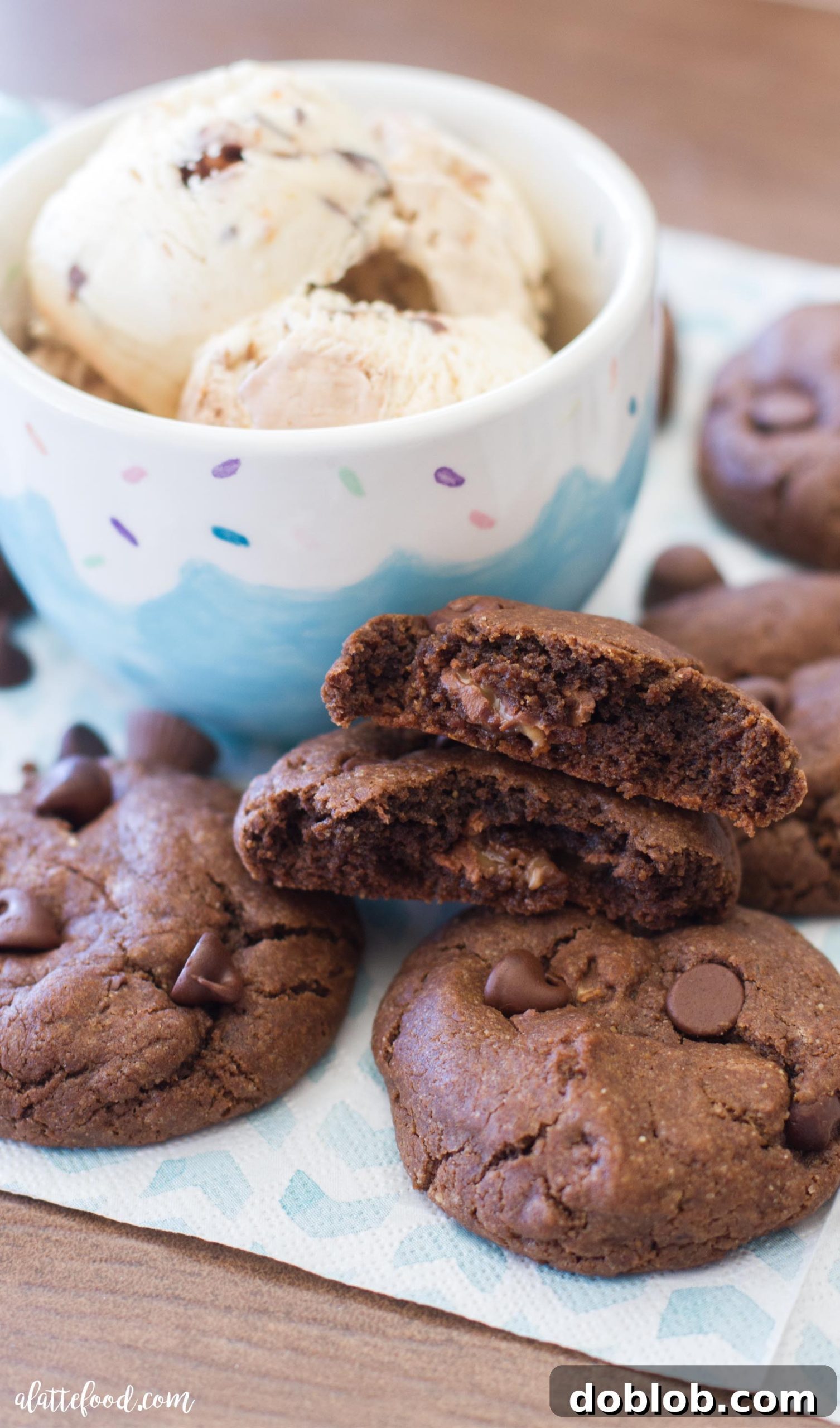 Double chocolate peanut butter caramel cookie cut in half, revealing a gooey caramel center