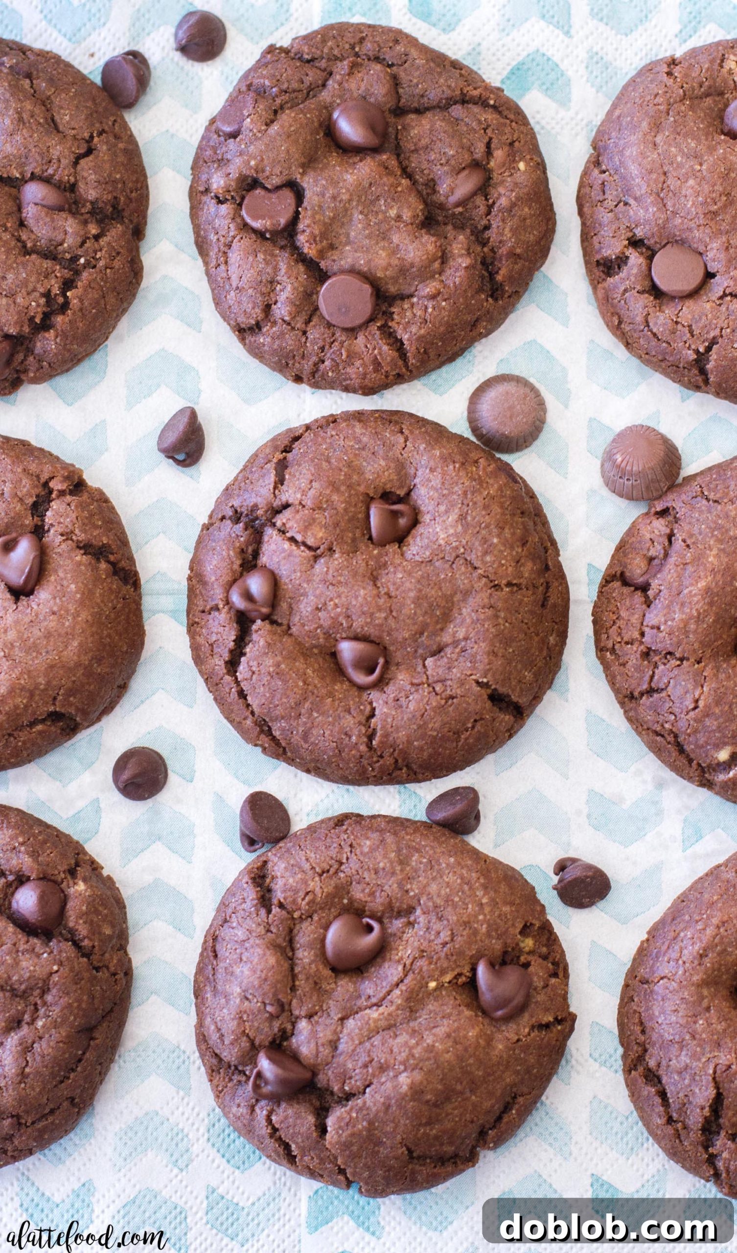 Hand holding a double chocolate peanut butter caramel cookie, showcasing its chewy texture
