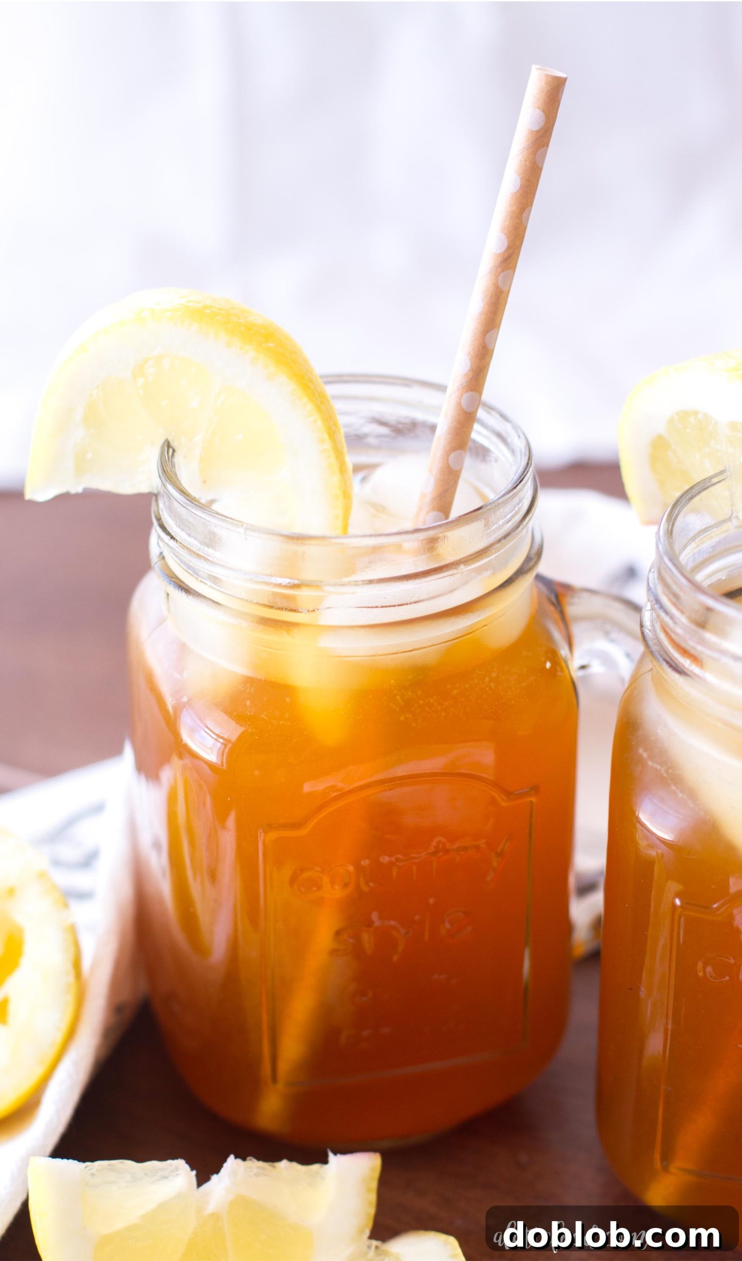 Refreshing Apricot Lemon Iced Tea in a pitcher and glass