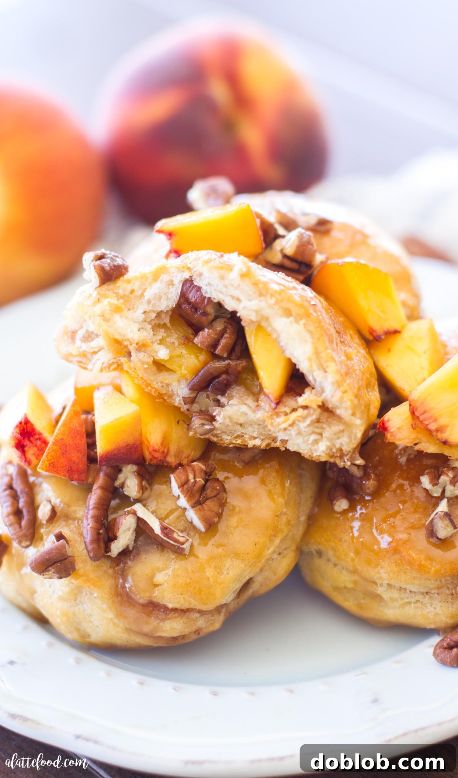 Close-up shot of a gooey peach pecan sticky bun, highlighting the caramel and pecans.