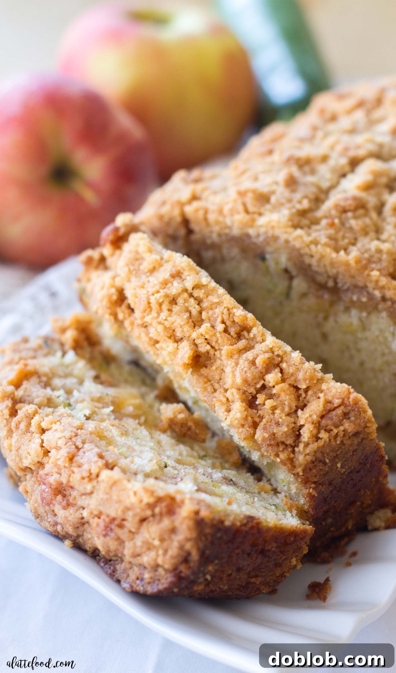 A close-up view of a single slice of Zucchini Apple Crumb Bread, showcasing the varied textures and inviting aroma.