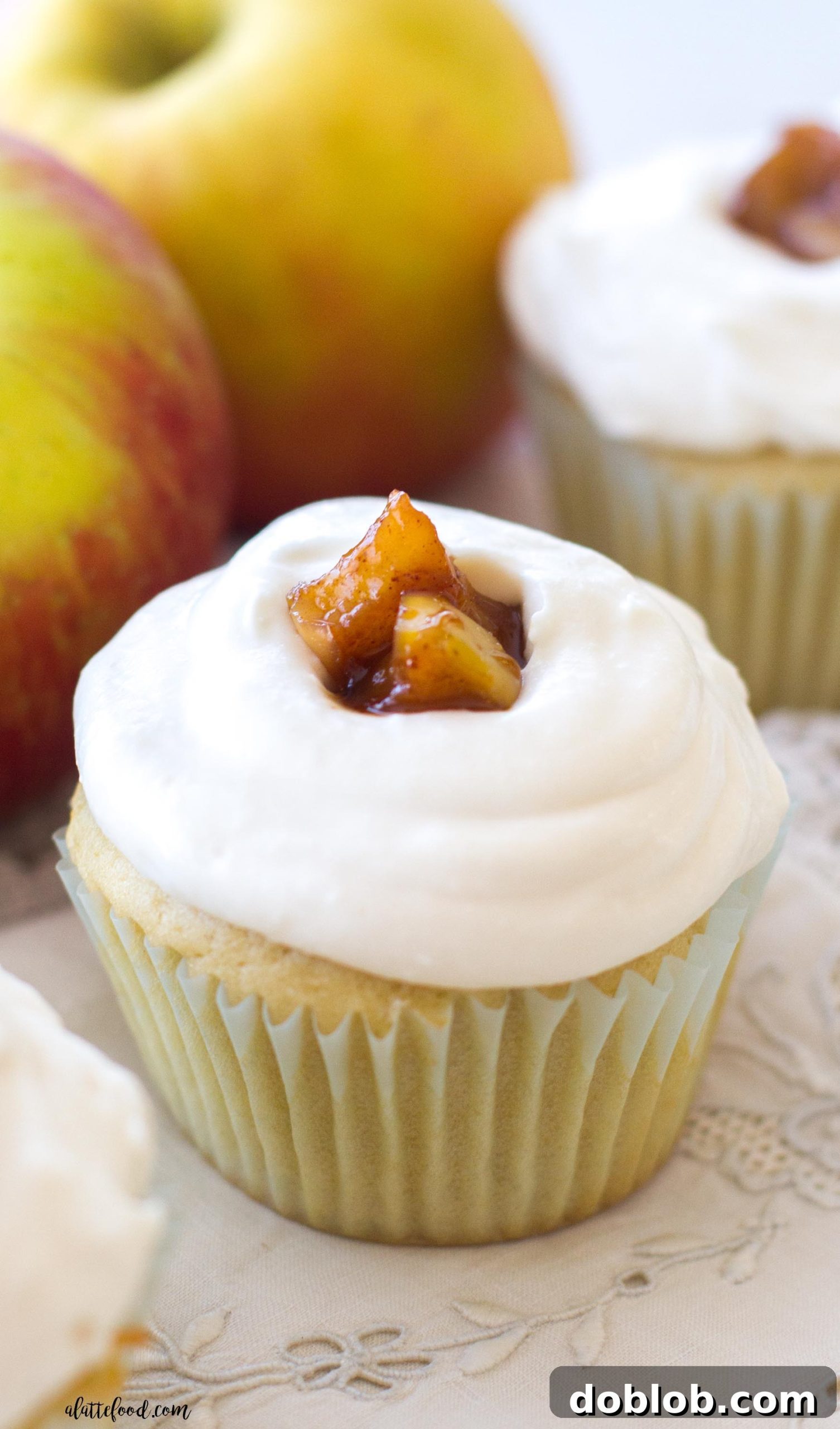 Spiced Apple Delights 2 Light, fluffy apple pie cupcakes filled with gooey apple pie filling and topped with delicate whipped cream frosting, perfect for fall celebrations.