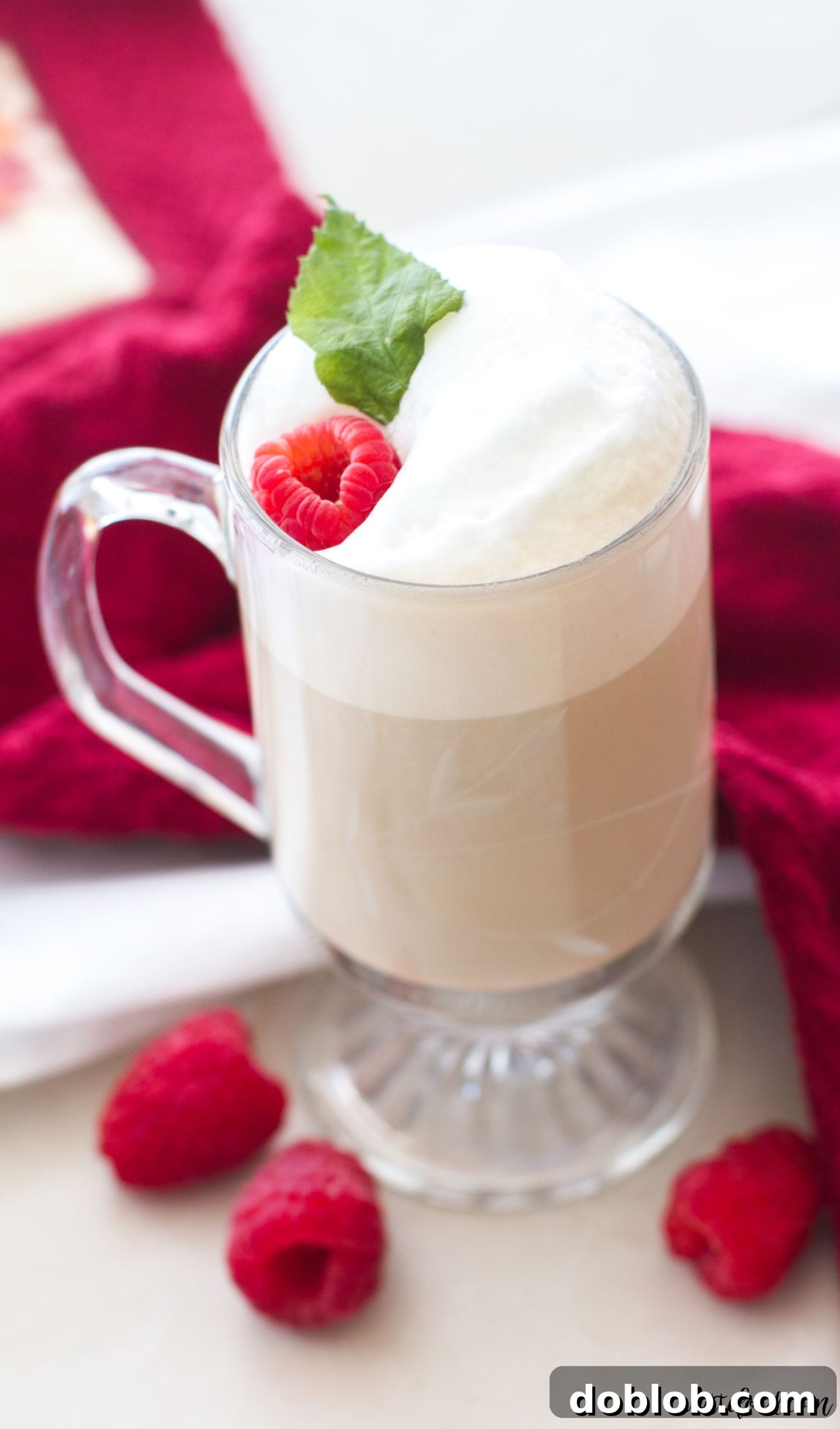 Another enticing shot of the White Chocolate Raspberry Vanilla Latte, presented with fresh raspberries as garnish, emphasizing its appealing presentation.