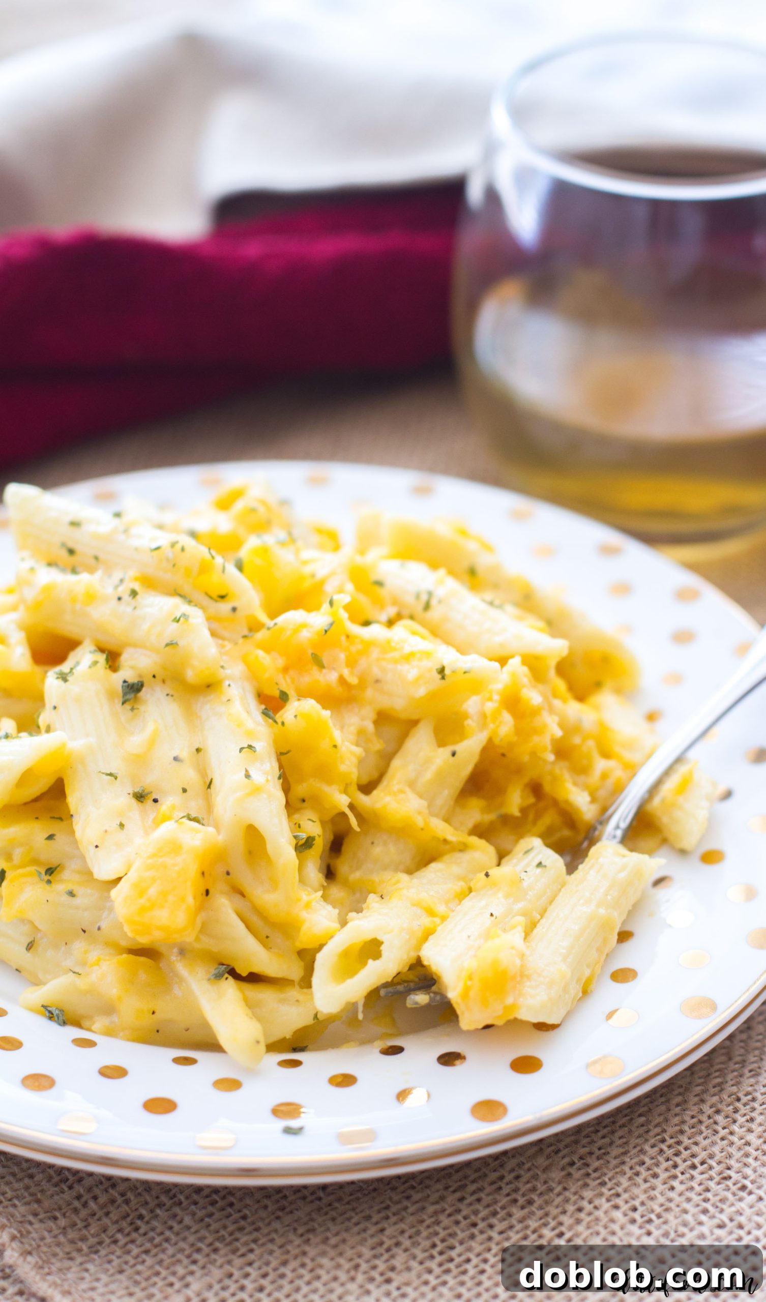 A bowl of hot penne butternut squash mac and cheese, ready to serve