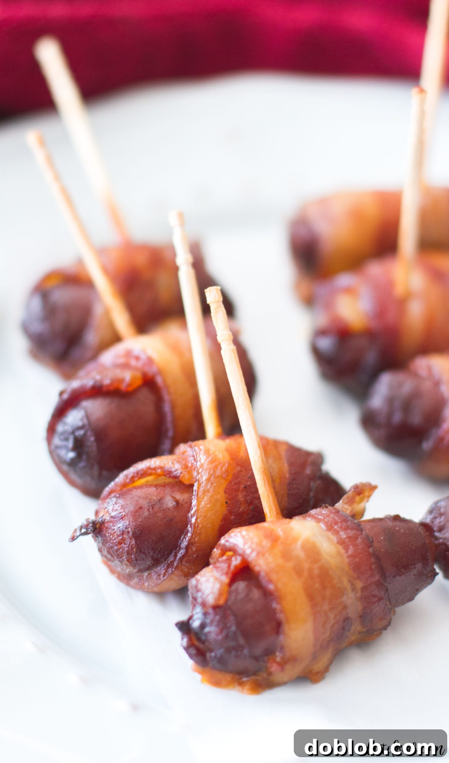 Close-up of Slow Cooker Peach Barbecue Bacon Wrapped Smokies cooking in a slow cooker.