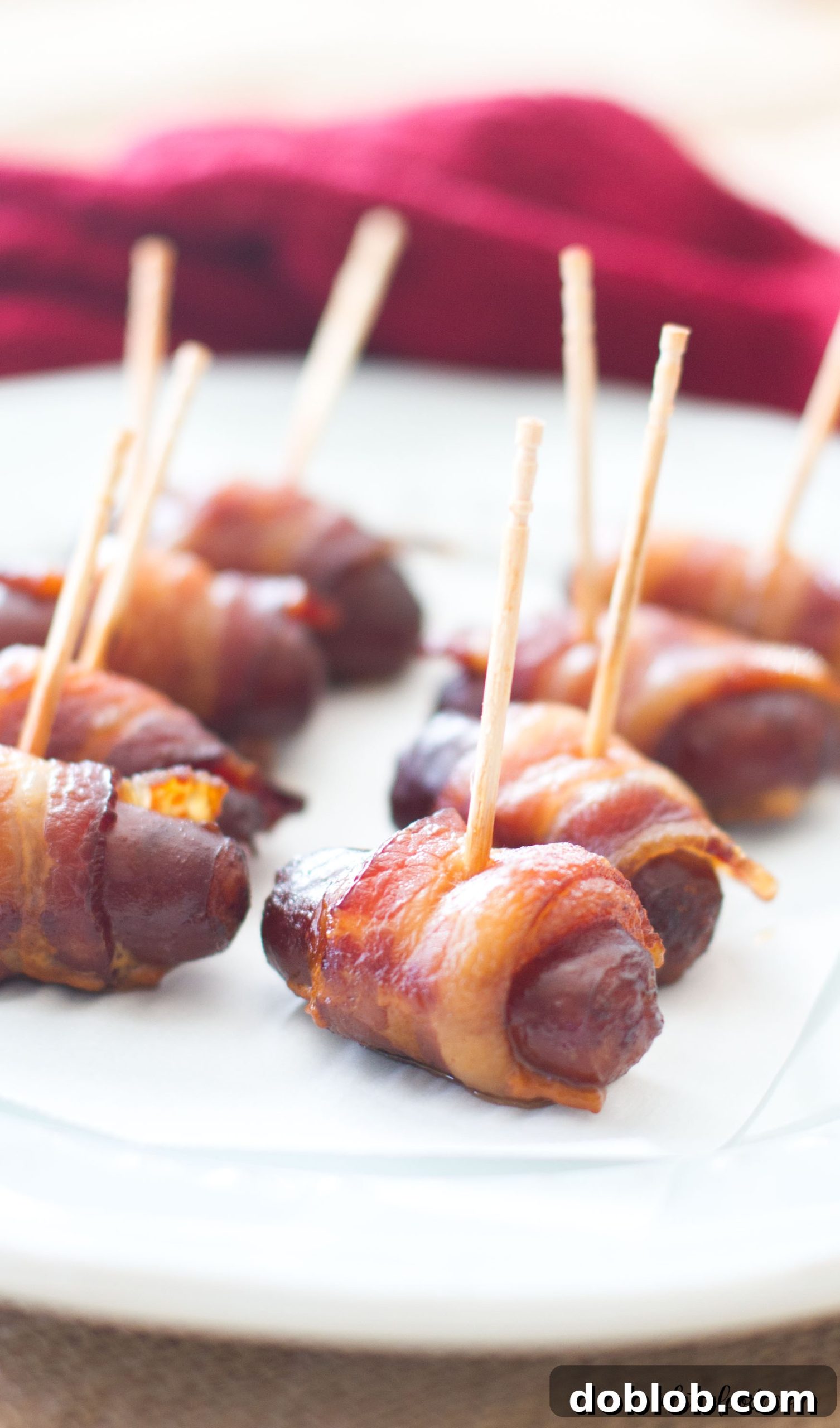 A large plate full of Slow Cooker Peach Barbecue Bacon Wrapped Smokies, perfect for sharing.