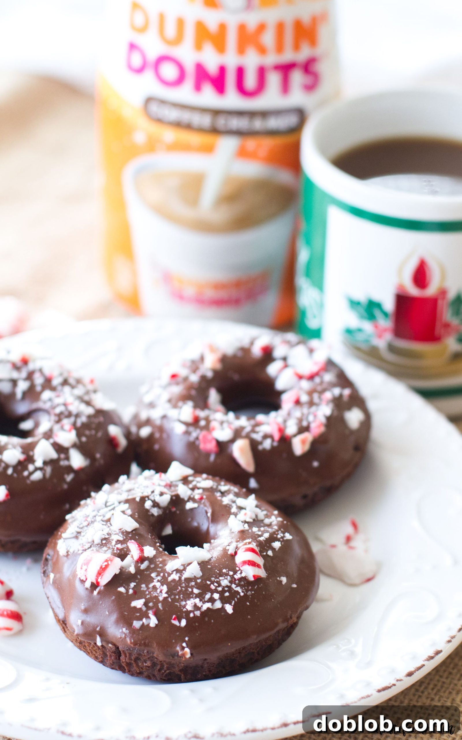 Elevate your holiday season with these decadent baked peppermint mocha donuts. A simple, yet sophisticated chocolate donut recipe infused with coffee, beautifully glazed with peppermint chocolate, and adorned with crushed peppermints. #peppermint #mocha #donut #chocolate #christmas These easy baked chocolate donuts are filled with coffee and rich chocolate, and topped with a chocolate peppermint glaze. The perfect Christmas dessert! A simple chocolate donut recipe you're sure to love!