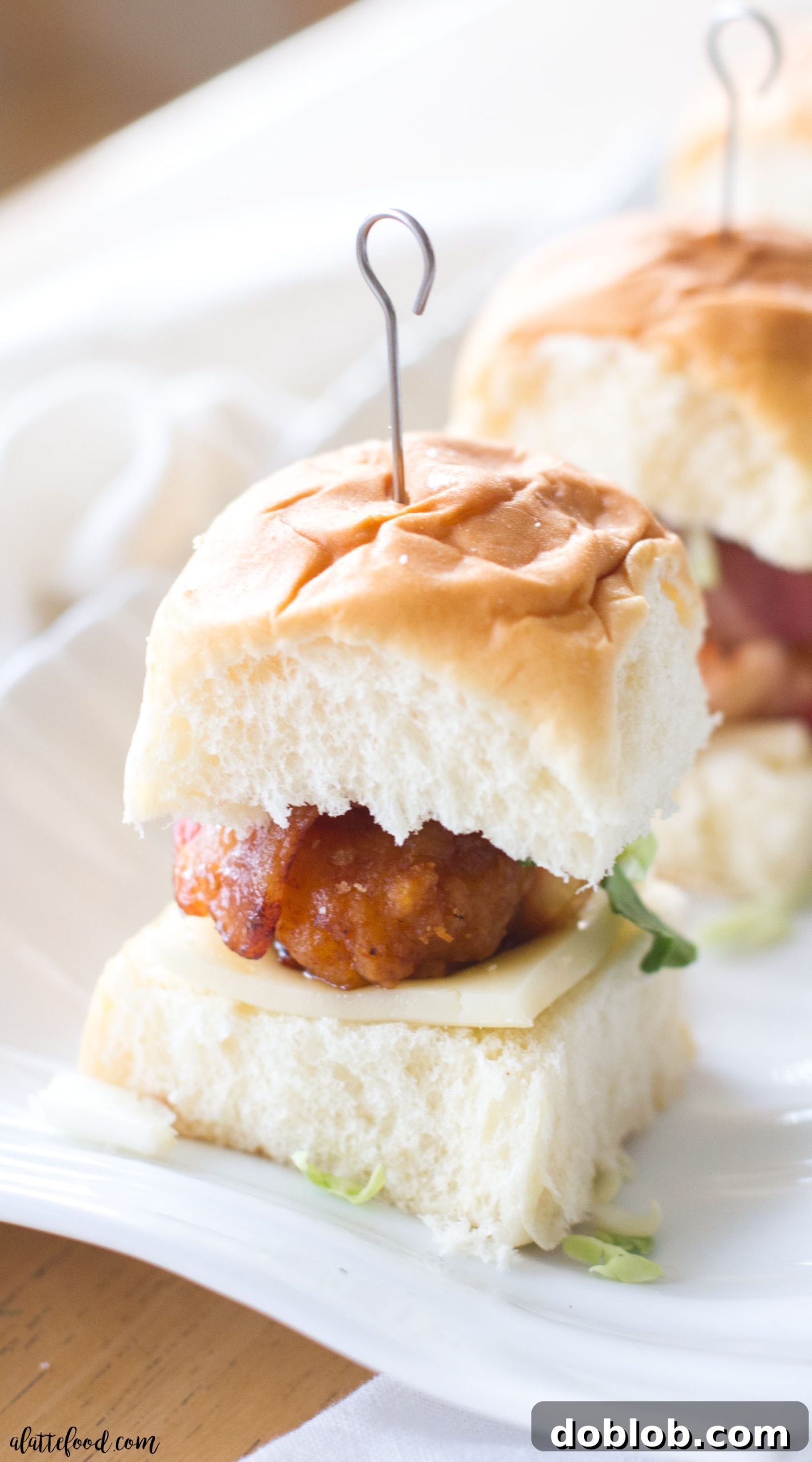 Honey-Glazed Bacon Wrapped Chicken Sliders 53 Close-up of golden-brown bacon wrapped chicken sliders on a platter, ready to serve