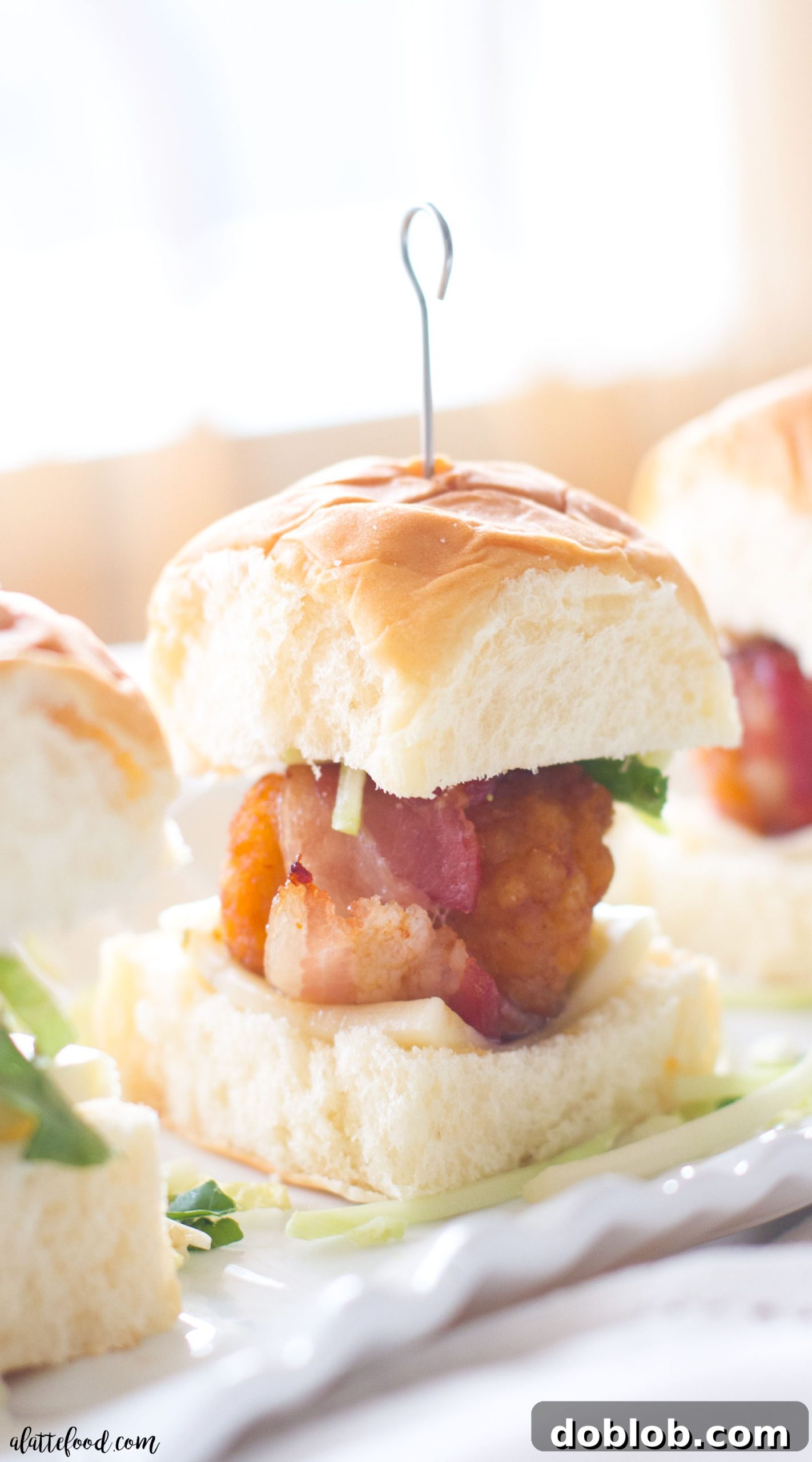 A tray of freshly baked bacon wrapped honey BBQ chicken pieces, before assembly