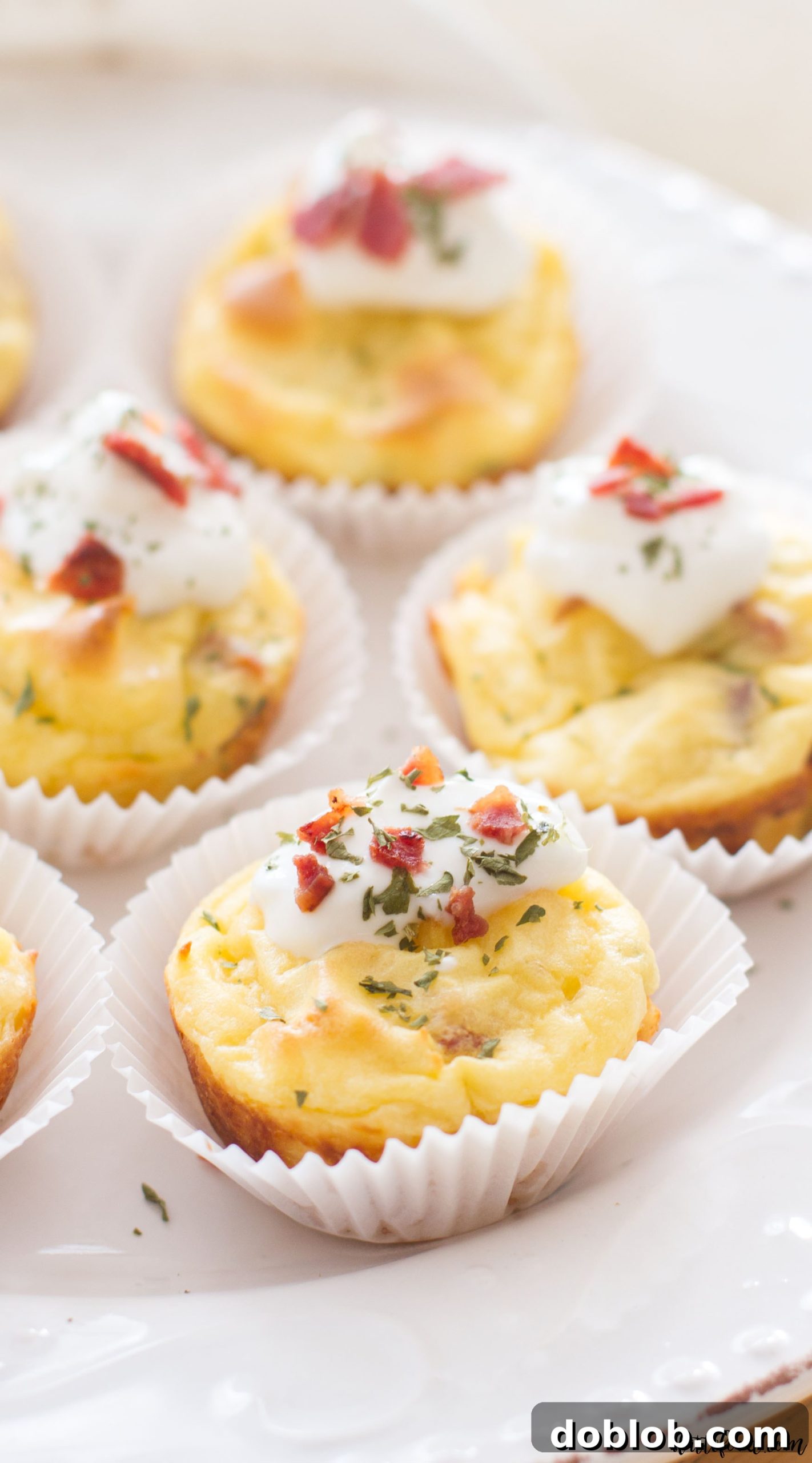 Crispy Bacon and Chive Potato Puffs 12 Golden brown bacon and chive mashed potato puffs arranged on a platter, ready to serve as a delicious game day appetizer.