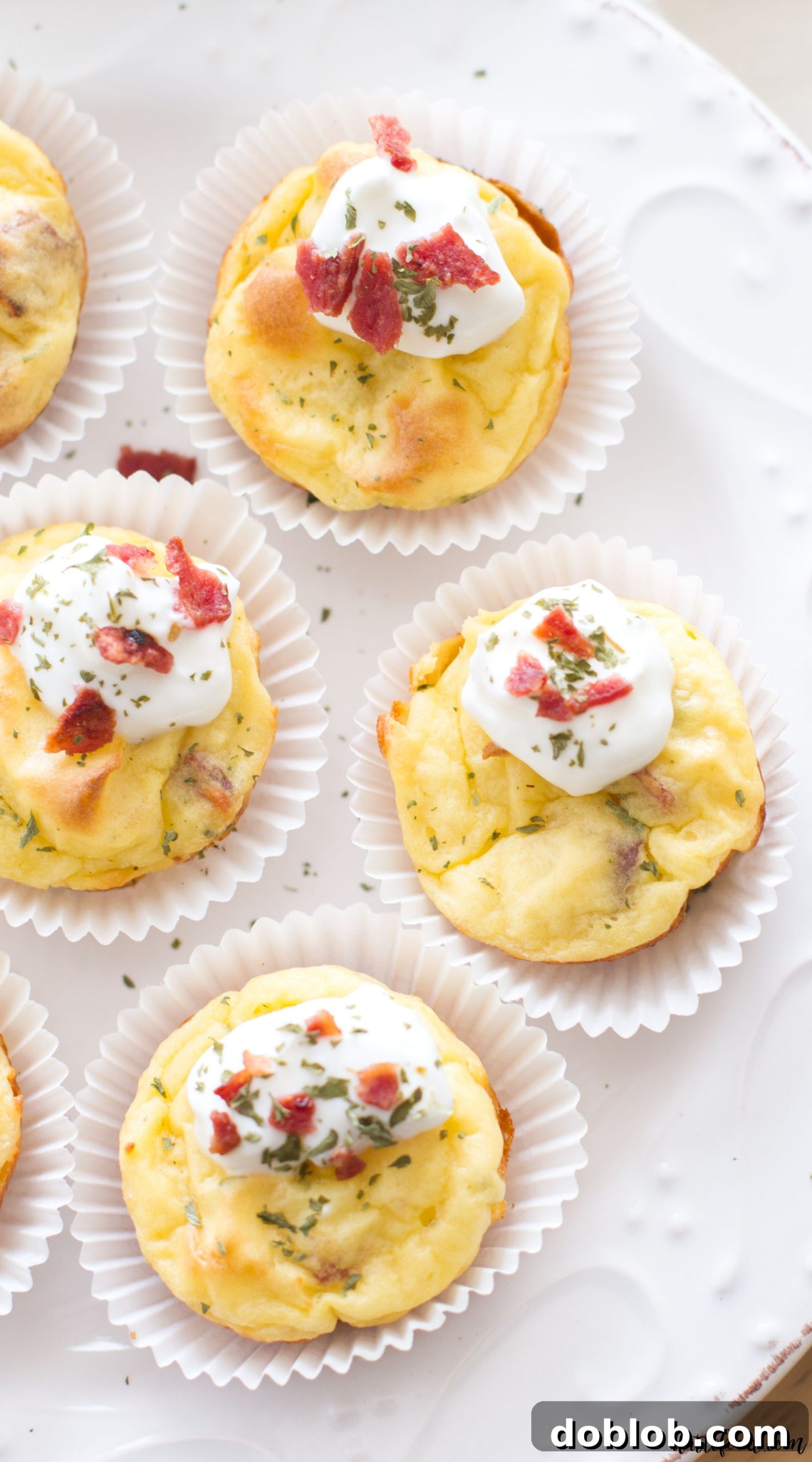 Crispy on the outside, soft on the inside: a close-up of a mashed potato puff being lifted from a mini muffin tin.