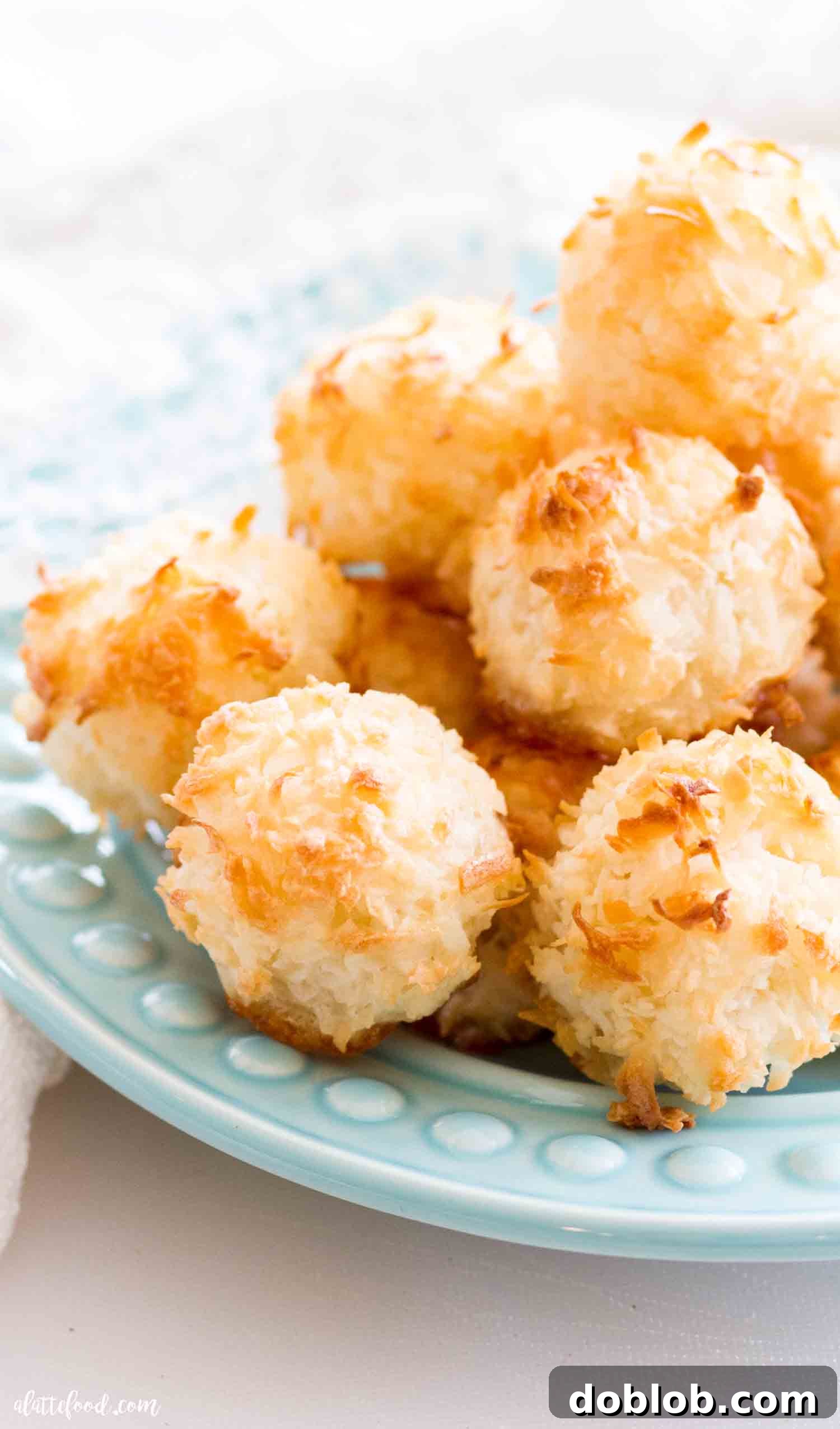 Homemade coconut macaroons are made with egg whites, coconut and sugar (no sweetened condensed milk in this recipe). Made from scratch, these coconut macaroons are so easy to make! #dessert #coconut #macaroon #cookie #recipe A close-up of easy macaroons made with coconut and egg whites, showcasing their moist interior