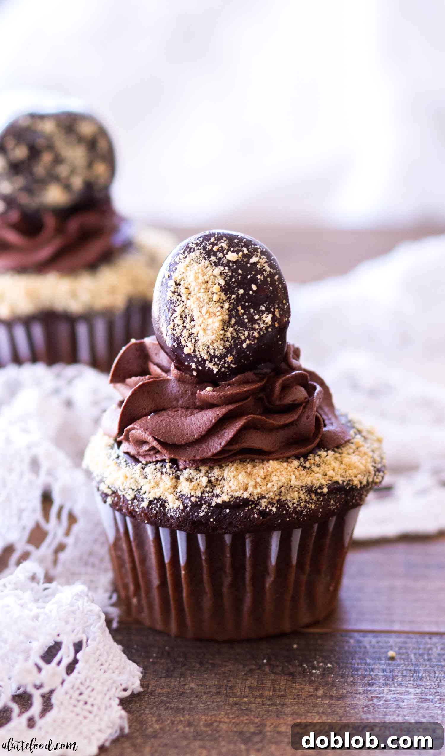 Close-up of chocolate s'mores cupcakes displayed on a rustic wooden surface