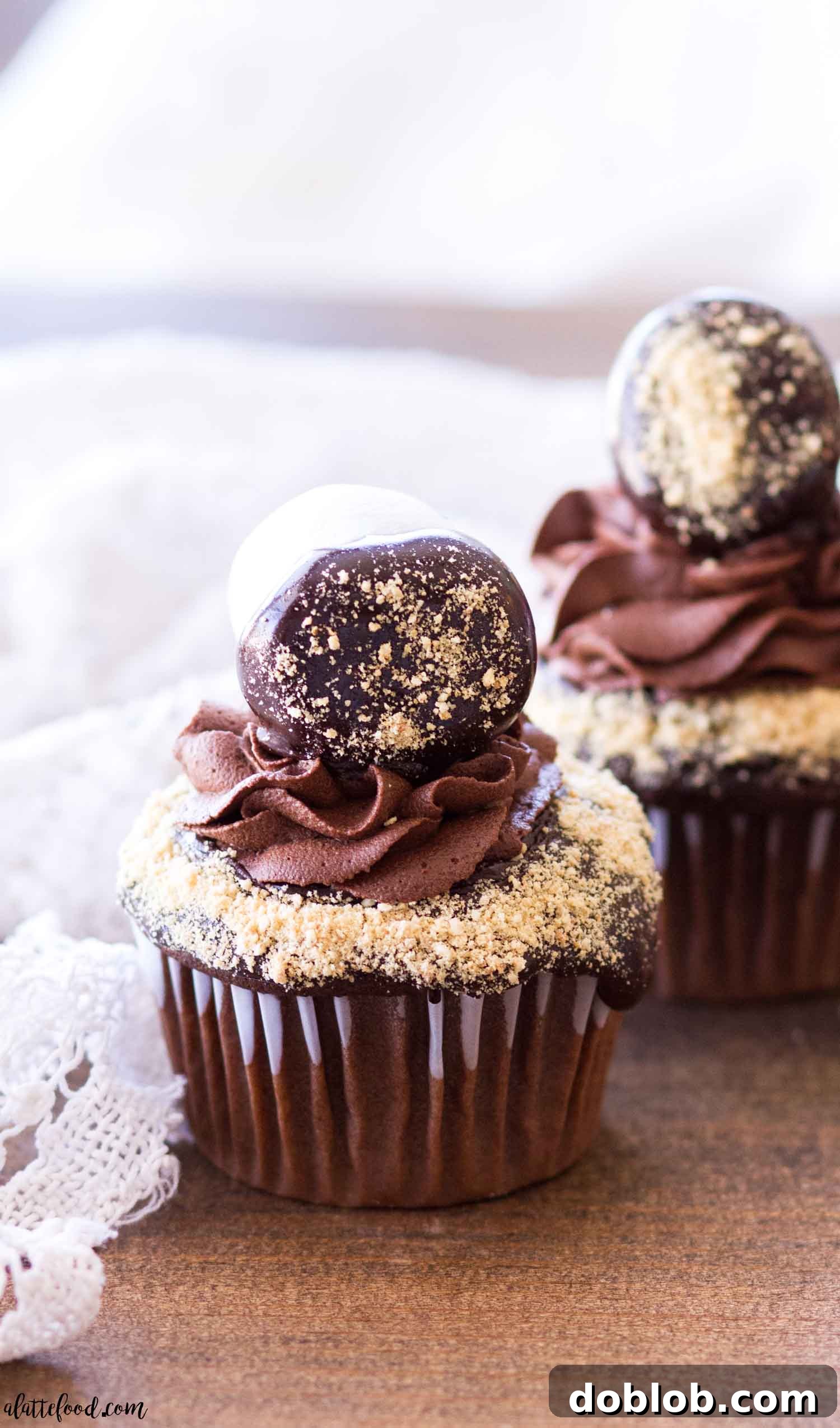 Close up of chocolate-covered marshmallows adorning the top of s'mores chocolate cupcakes