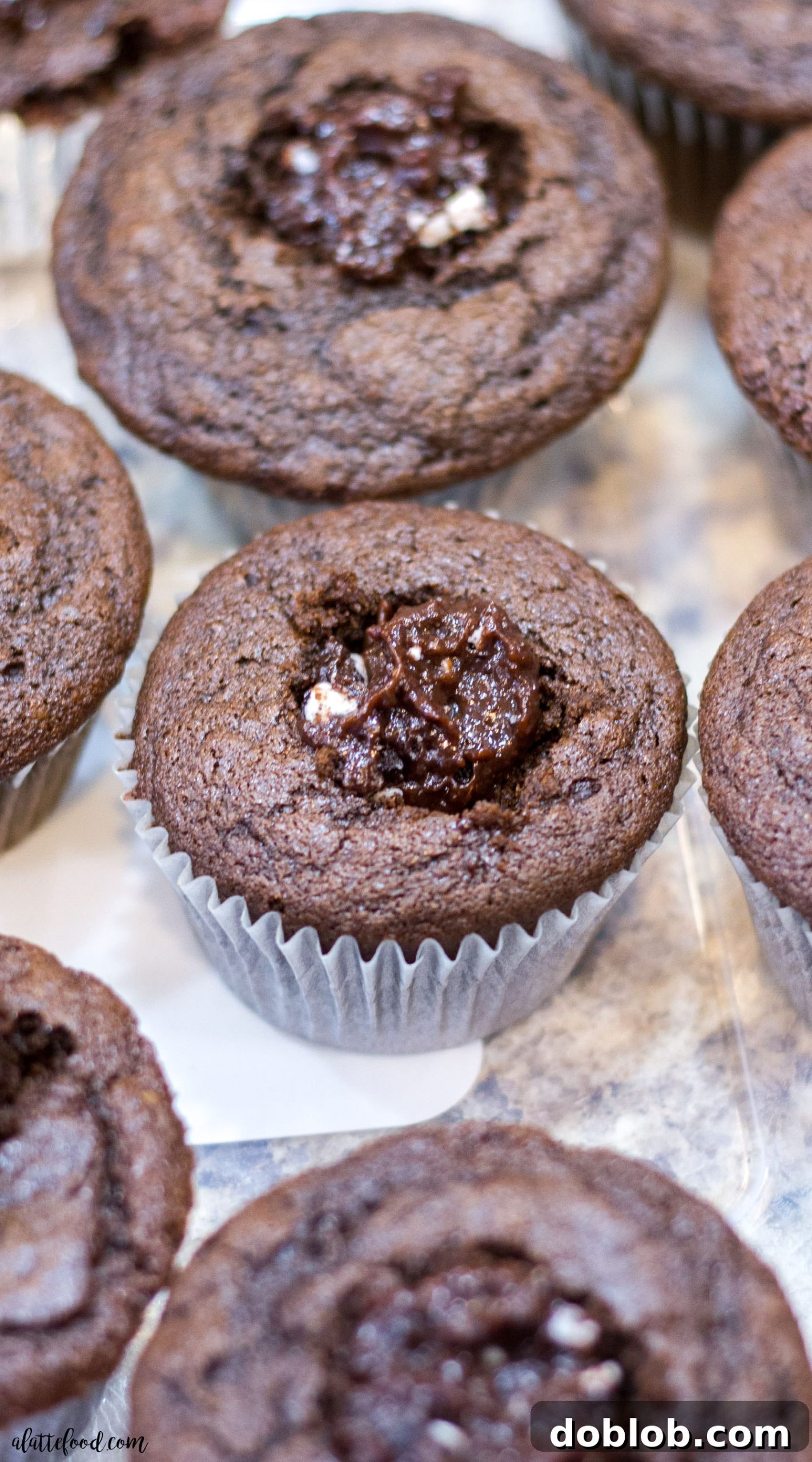 A trio of Oreo truffle stuffed chocolate cupcakes, beautifully frosted with vanilla buttercream, showcasing the irresistible combination of flavors and textures.