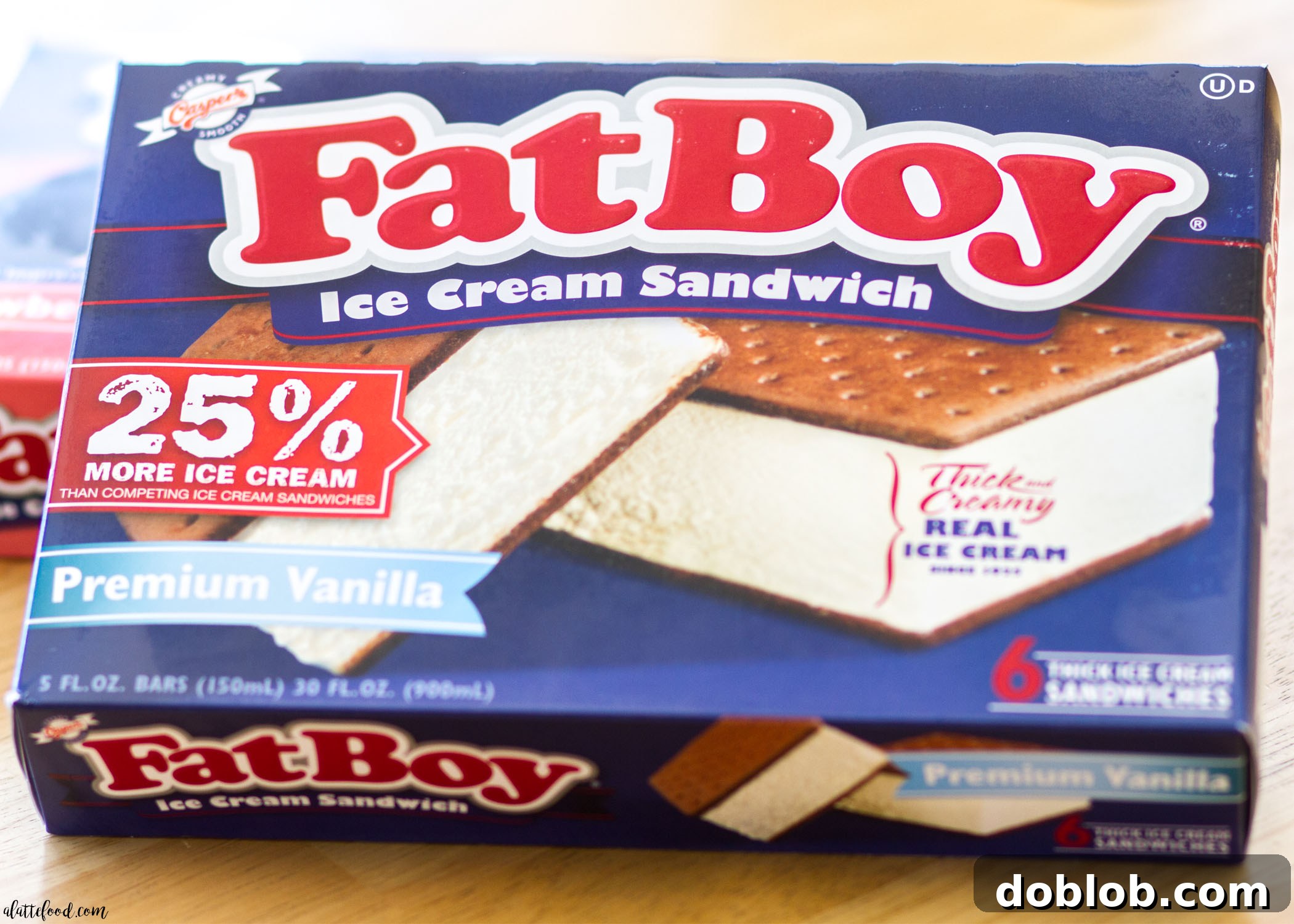 Close-up of a slice of Banana Split Ice Cream Sandwich Cake showing the layers of ice cream, banana, and toppings.