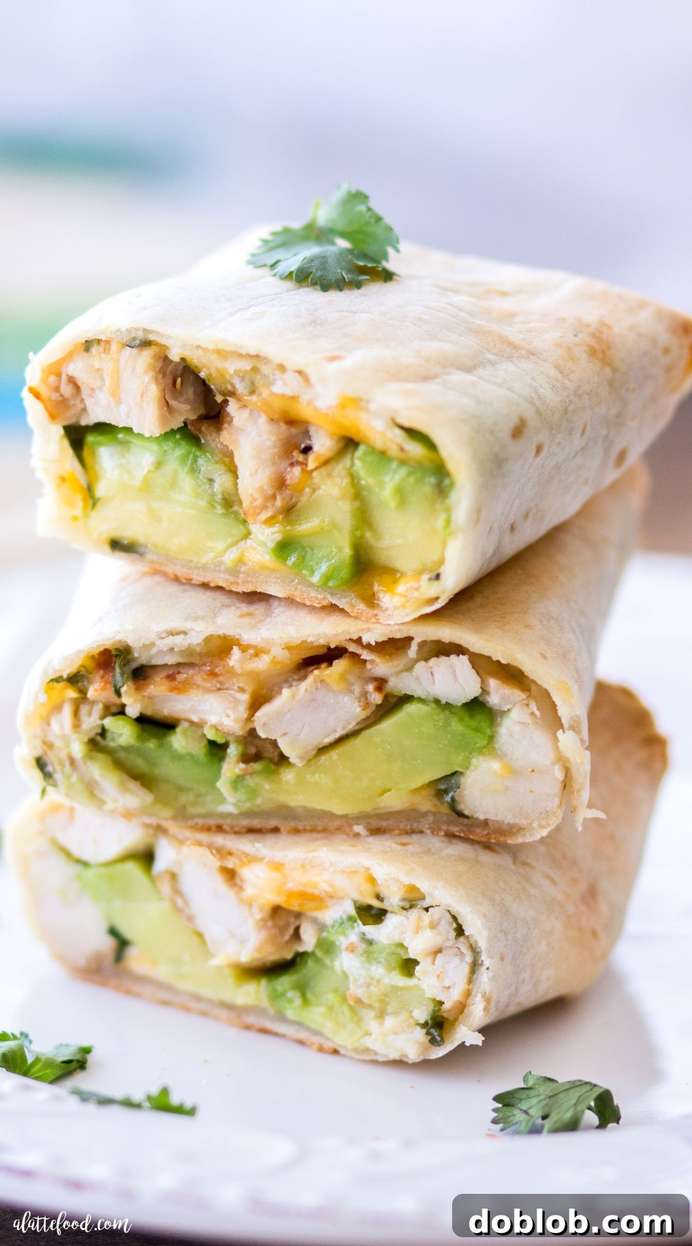 Hearty Oven-Baked Chicken & Avocado Burritos 8 A vibrant, delicious Baked Avocado Chicken Burrito on a plate, ready to be served. The image evokes a sense of freshness and homemade goodness.