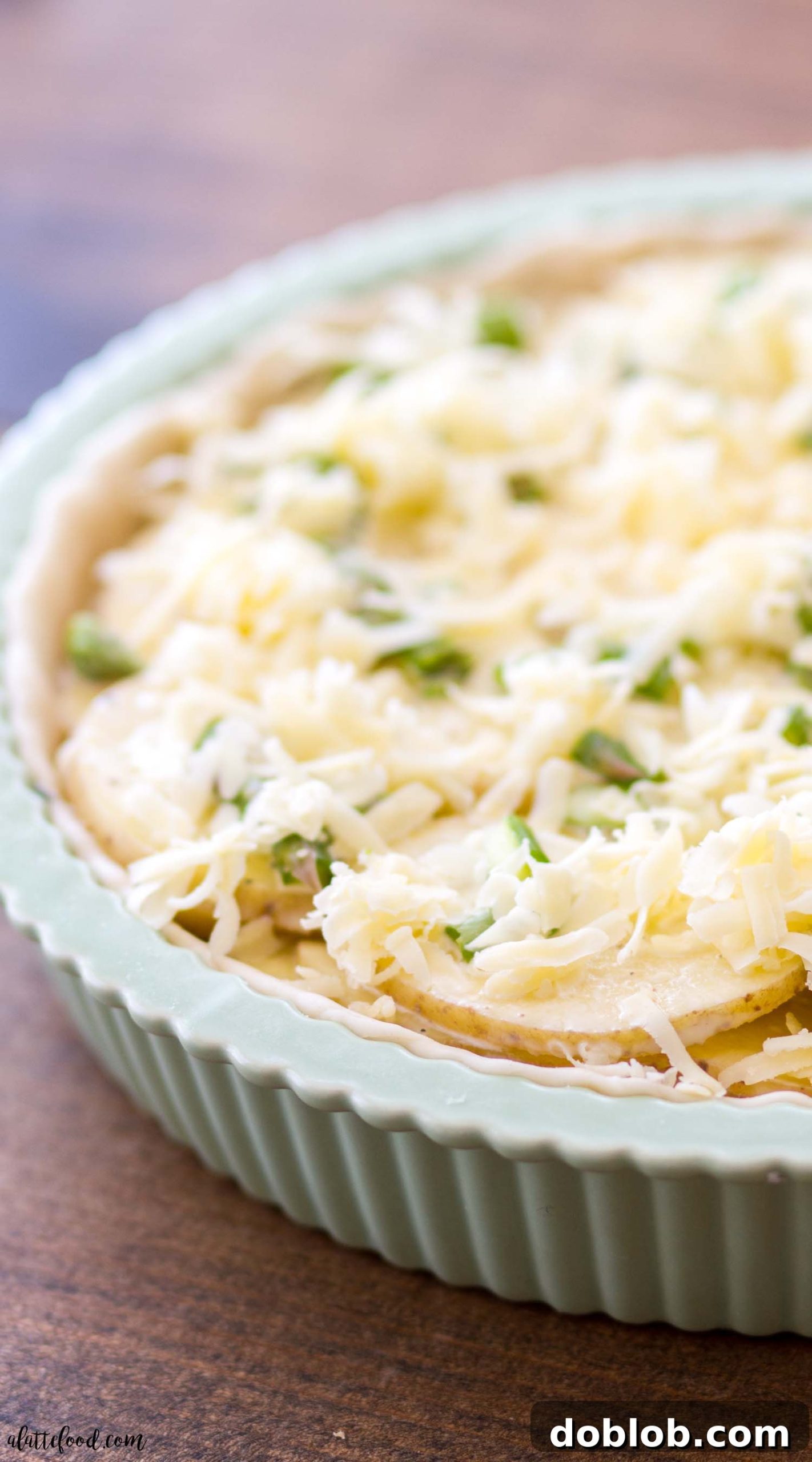 A close-up view of the interior of a Cheesy Asparagus Potato Tart, highlighting the creamy filling.