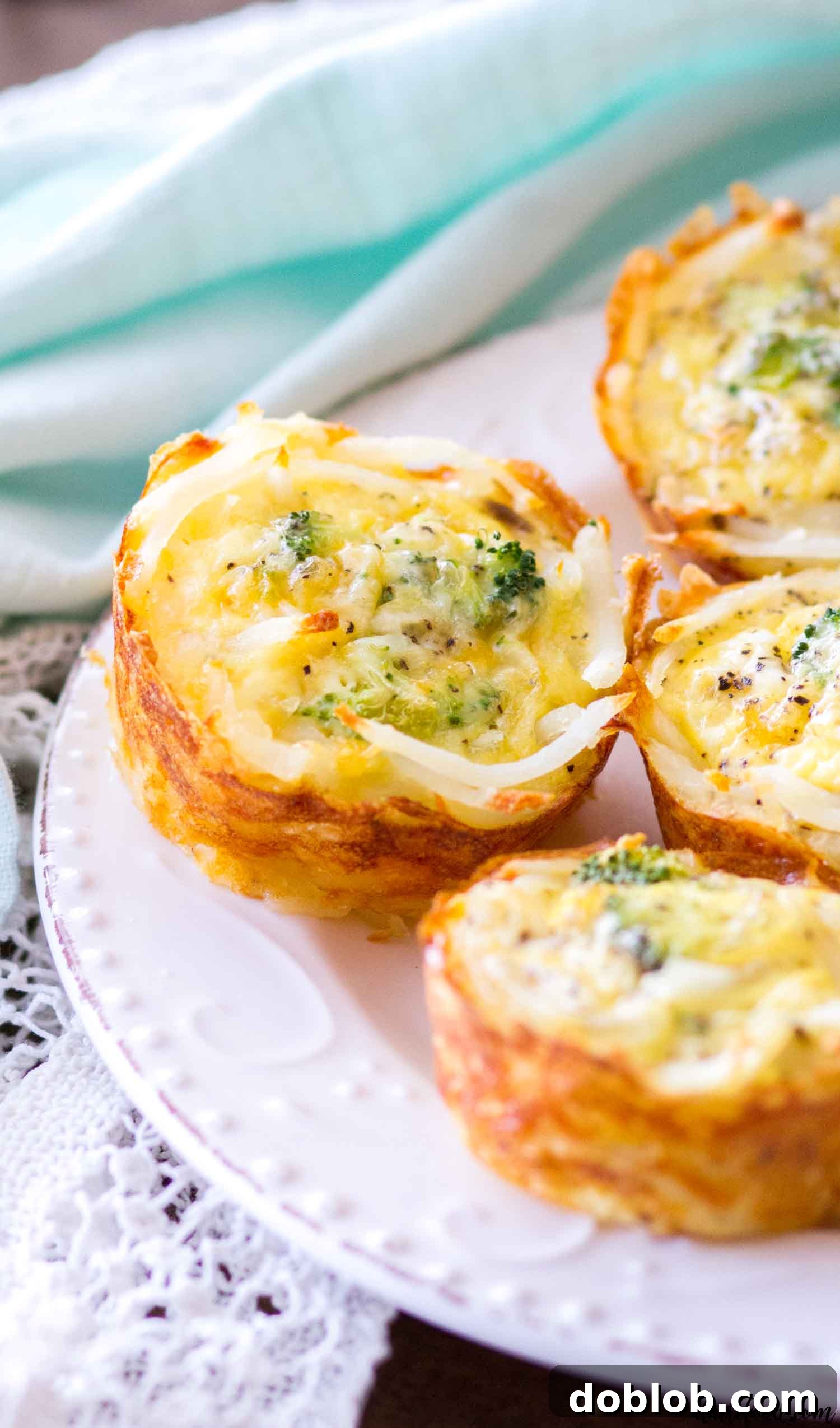 A stack of perfectly baked hash brown crusted quiche cups with broccoli and cheddar, ready to be served