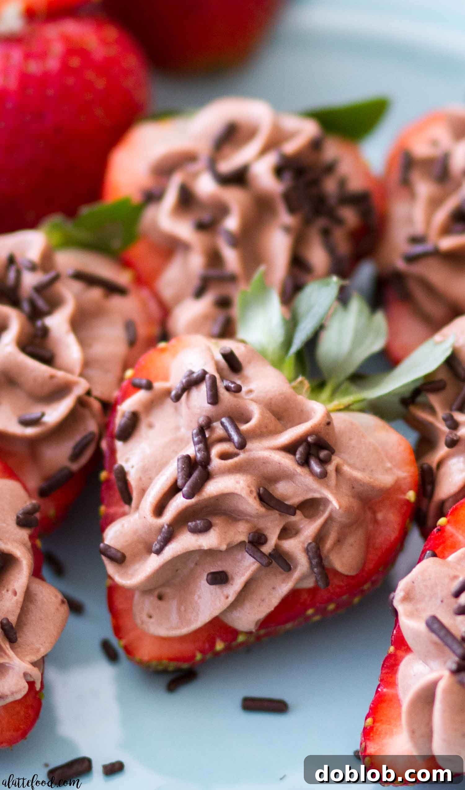 Easy No Bake Chocolate Cheesecake Stuffed Strawberries Fresh strawberries halved and generously piped with creamy no-bake chocolate cheesecake filling, ready for a delightful indulgence.