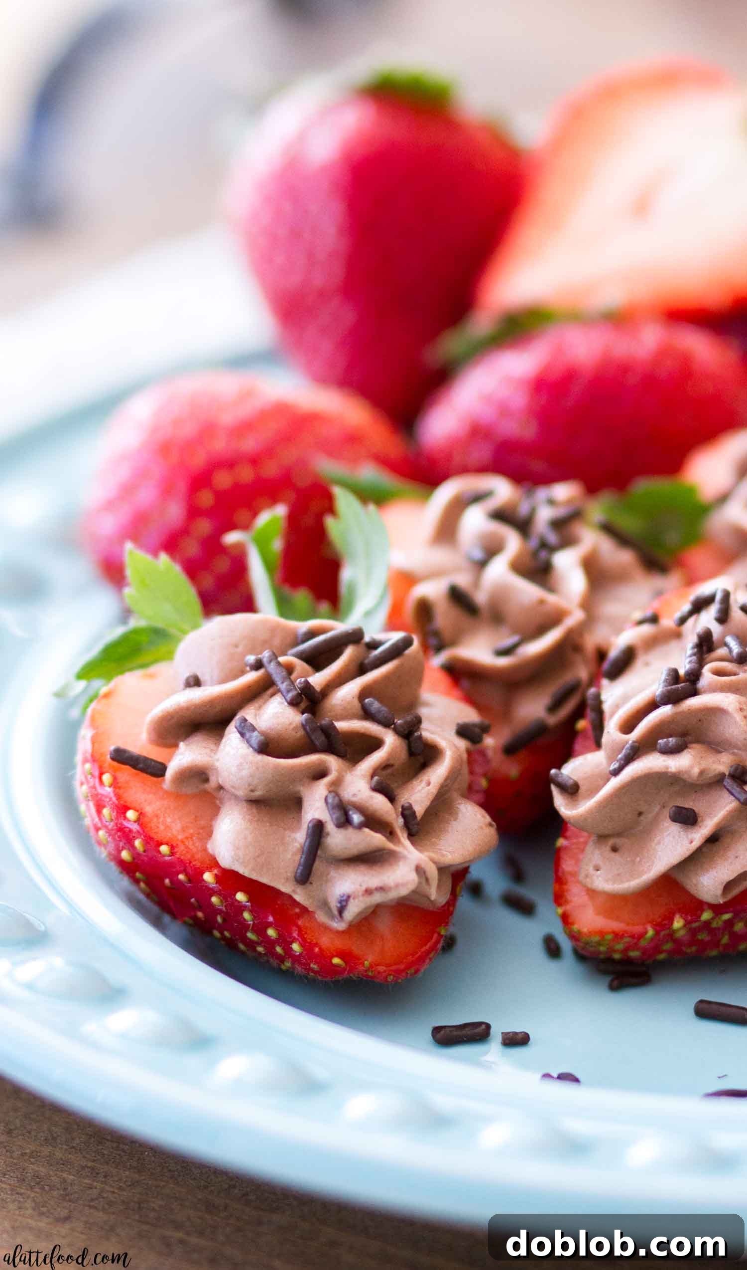 Simple Chocolate Cheesecake Stuffed Strawberries A close-up of a perfectly piped No Bake Chocolate Cheesecake Stuffed Strawberry, showcasing its elegant appearance.