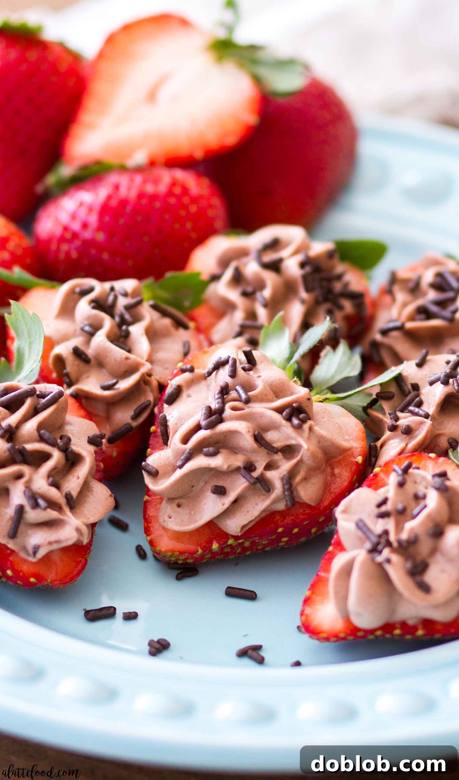 No Bake Chocolate Cheesecake Strawberries A beautifully arranged plate of chocolate cheesecake stuffed strawberries, ready to be served.