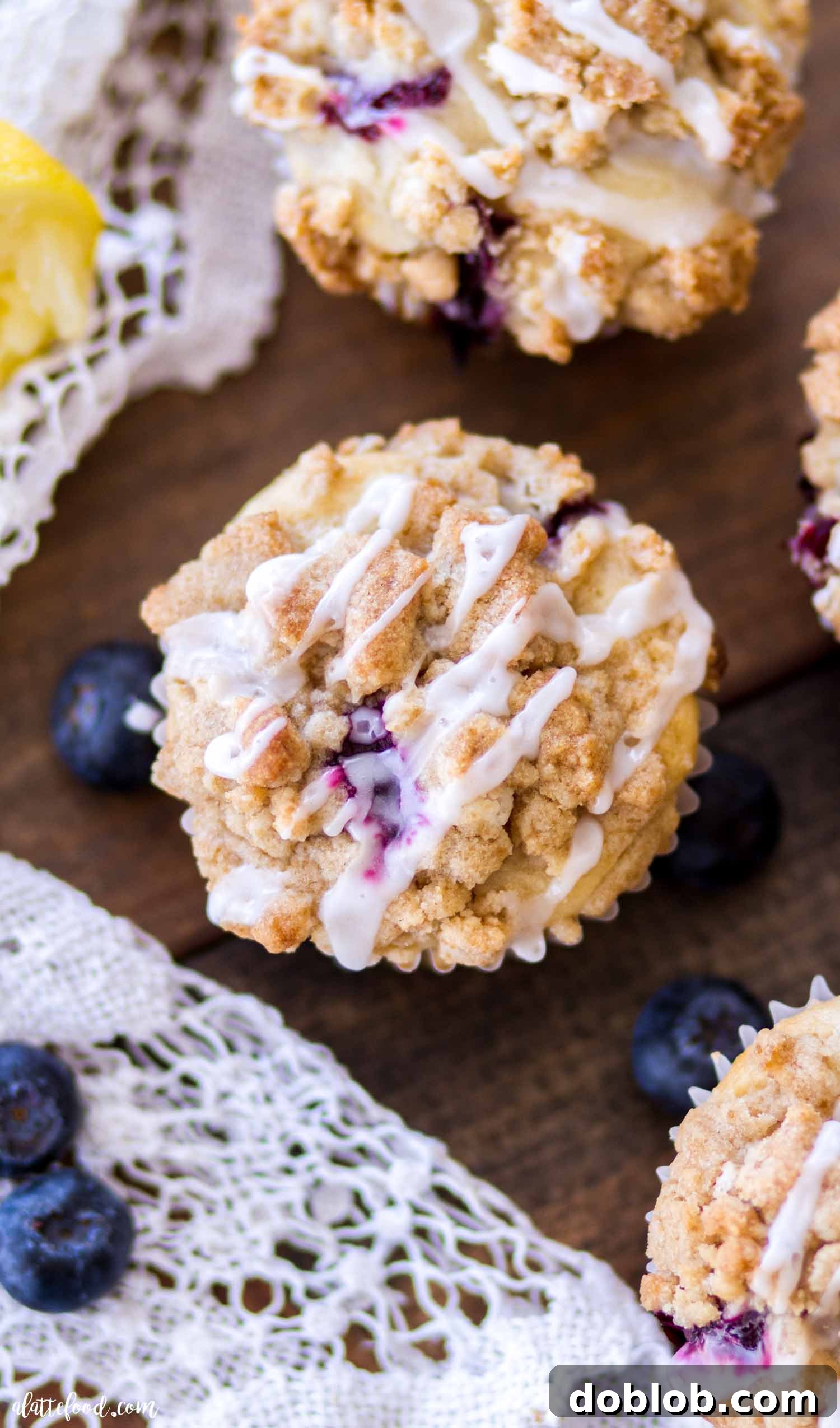 Moist Lemon Blueberry Muffins with irresistible crumb topping Close-up of fluffy blueberry lemon muffins topped with a golden crumb cake and vibrant lemon glaze
