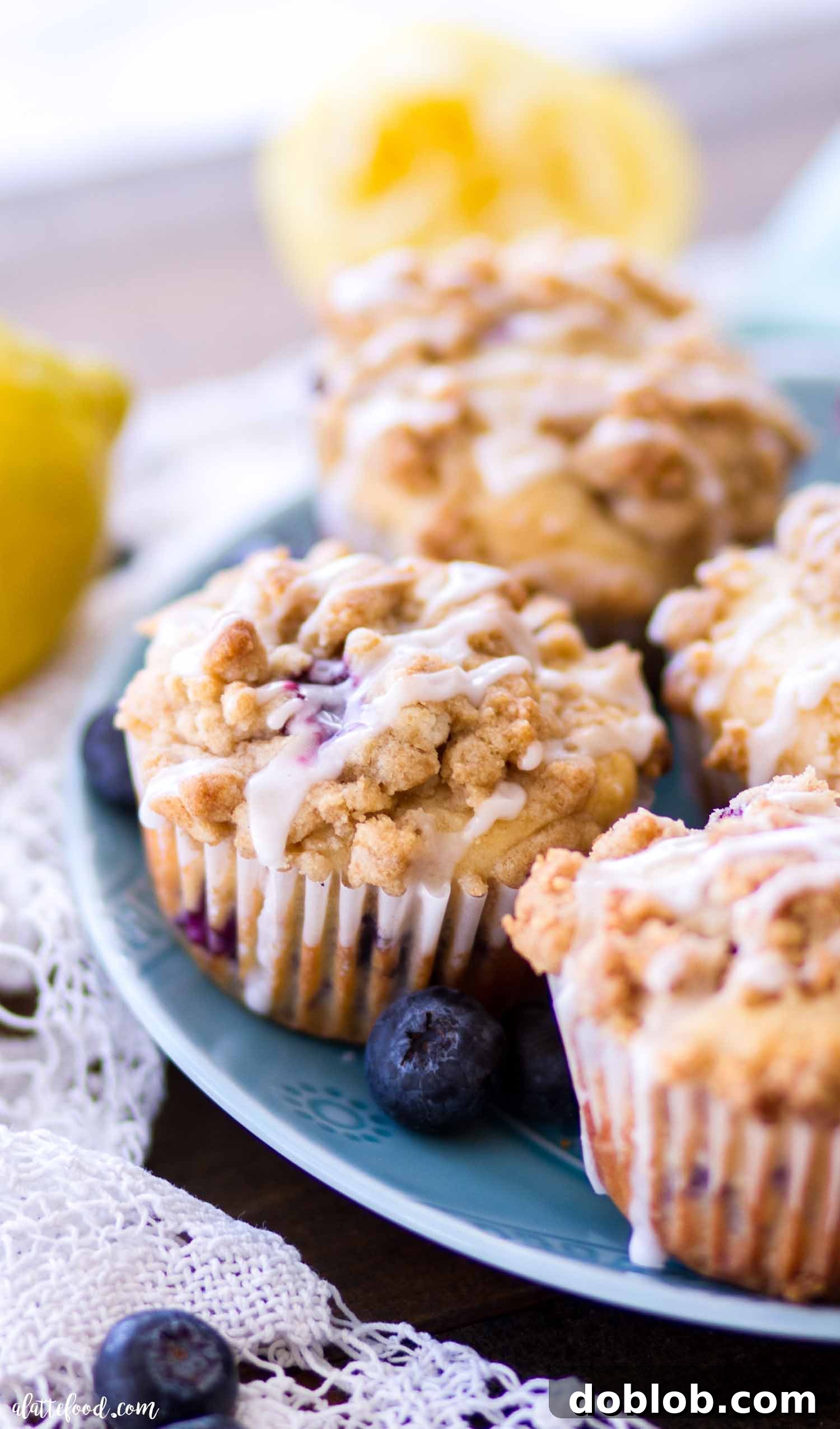 Easy Lemon Blueberry Muffins for breakfast or brunch Lemon Blueberry Crumb Cake muffins presented beautifully on a teal plate
