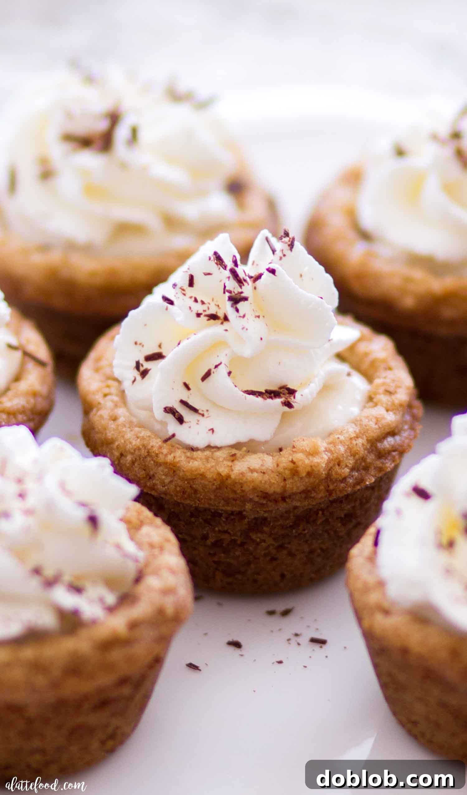 Fireside S'mores Cookie Cups 2 Delightful S'mores Cookie Cups, a perfect blend of graham cracker, mocha marshmallow, and chocolate, ready for any gathering.