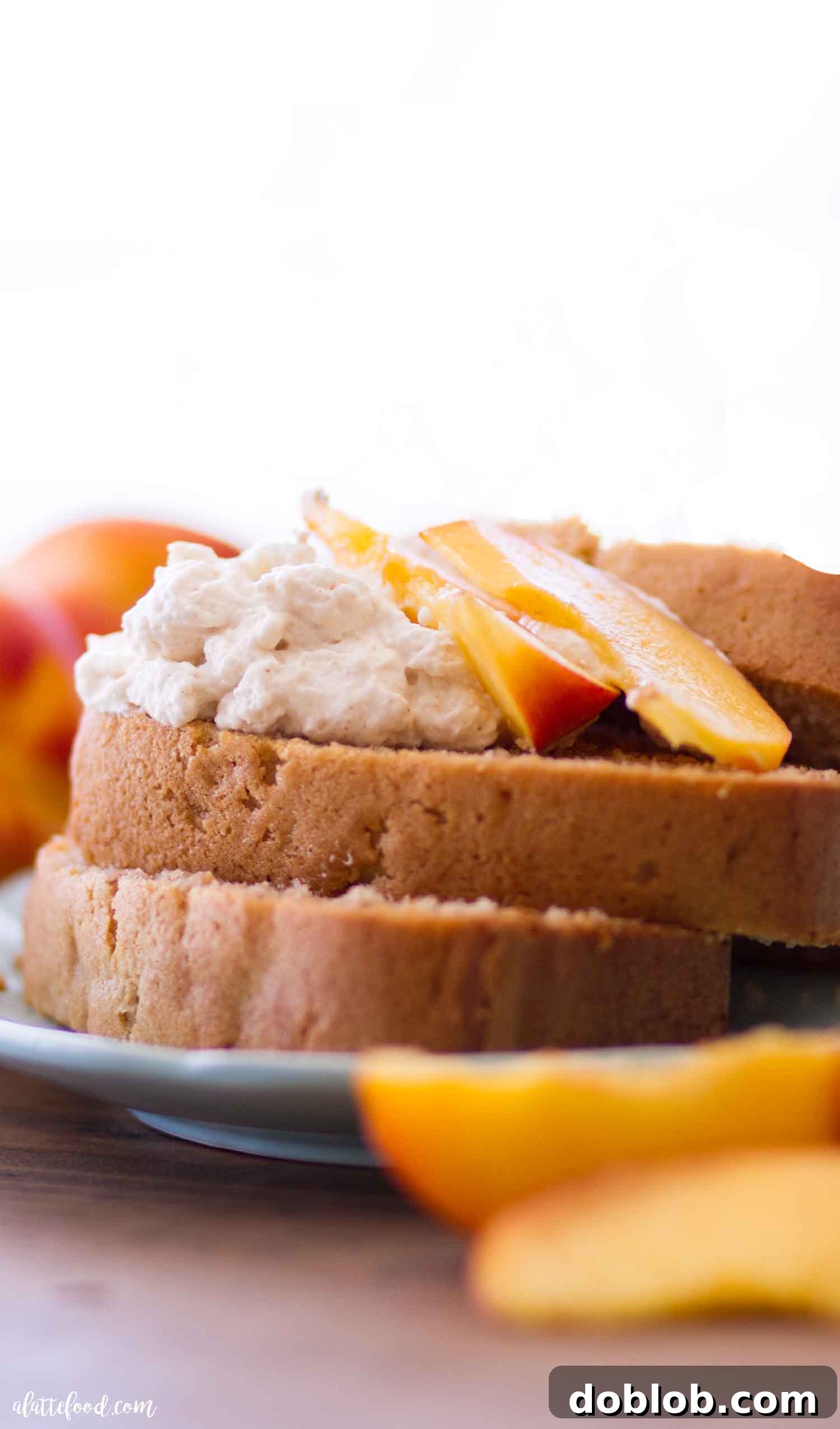 Homemade Peach Pound Cake with fresh peaches and whipped cream, a delightful summer dessert recipe.