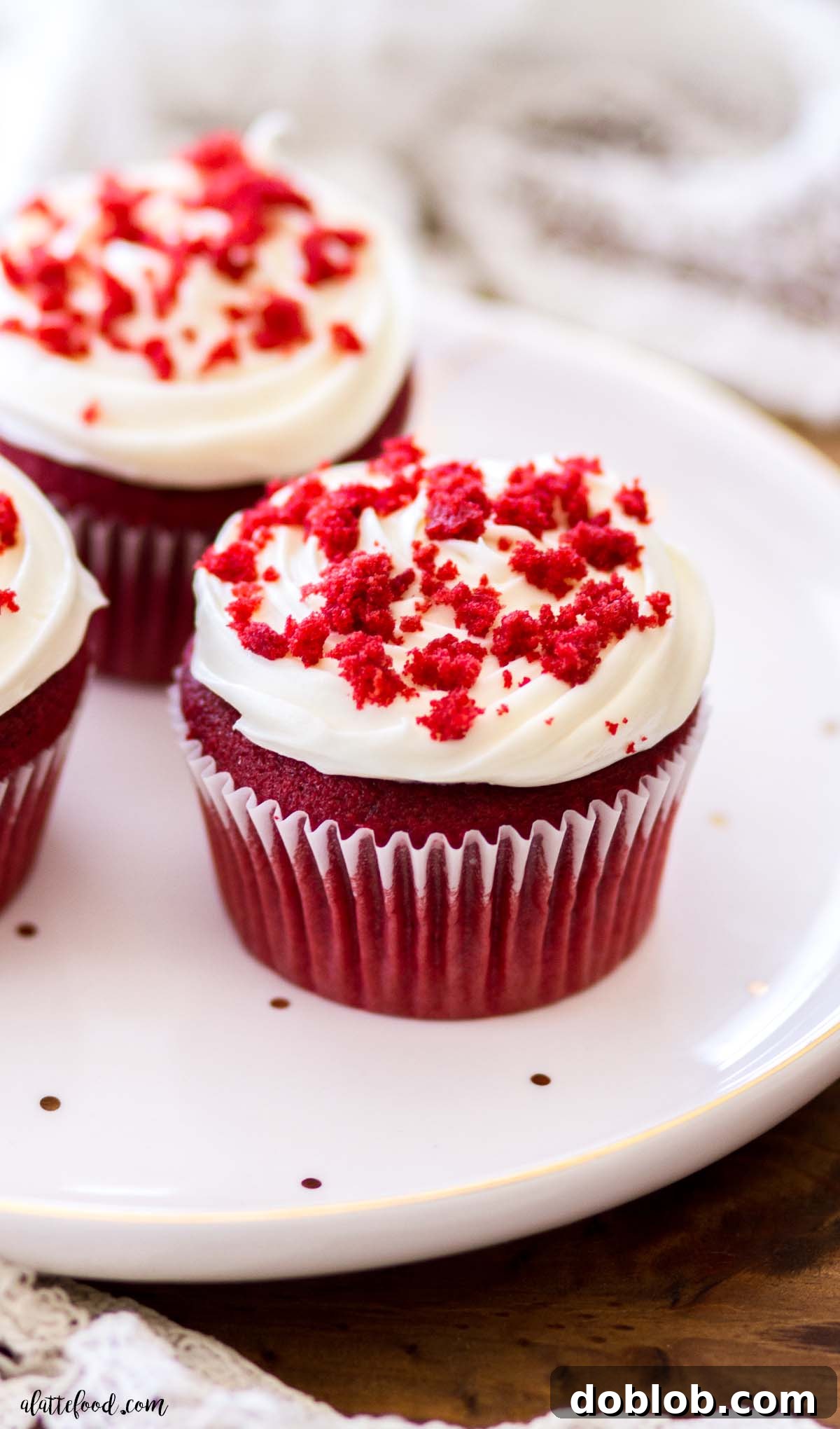Heavenly Red Velvet Cupcakes 6 three cupcakes (red velvet) with frosting and cake crumbles on polka dotted plate