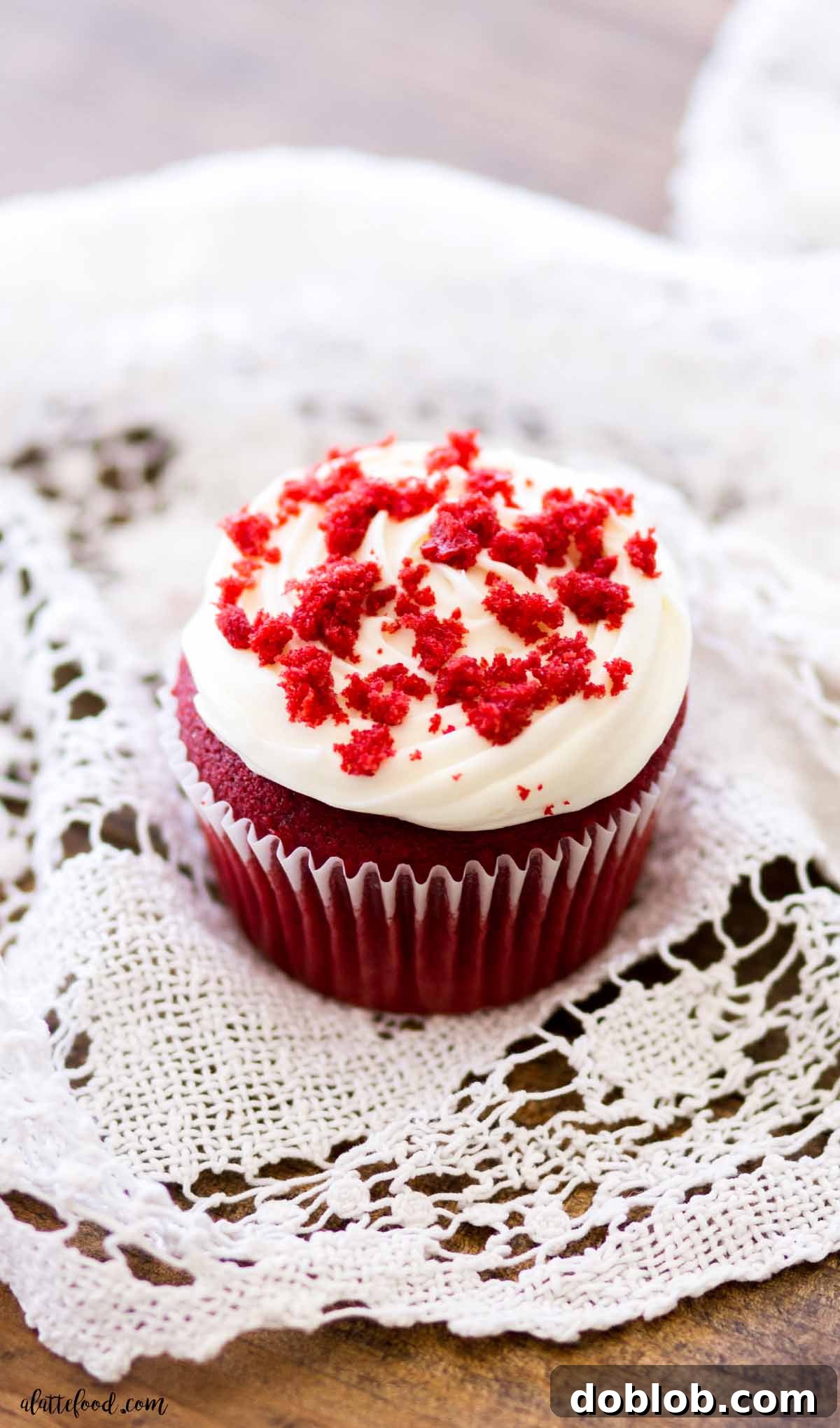 Heavenly Red Velvet Cupcakes 8 red velvet cupcakes with frosting on wooden board with lace towel