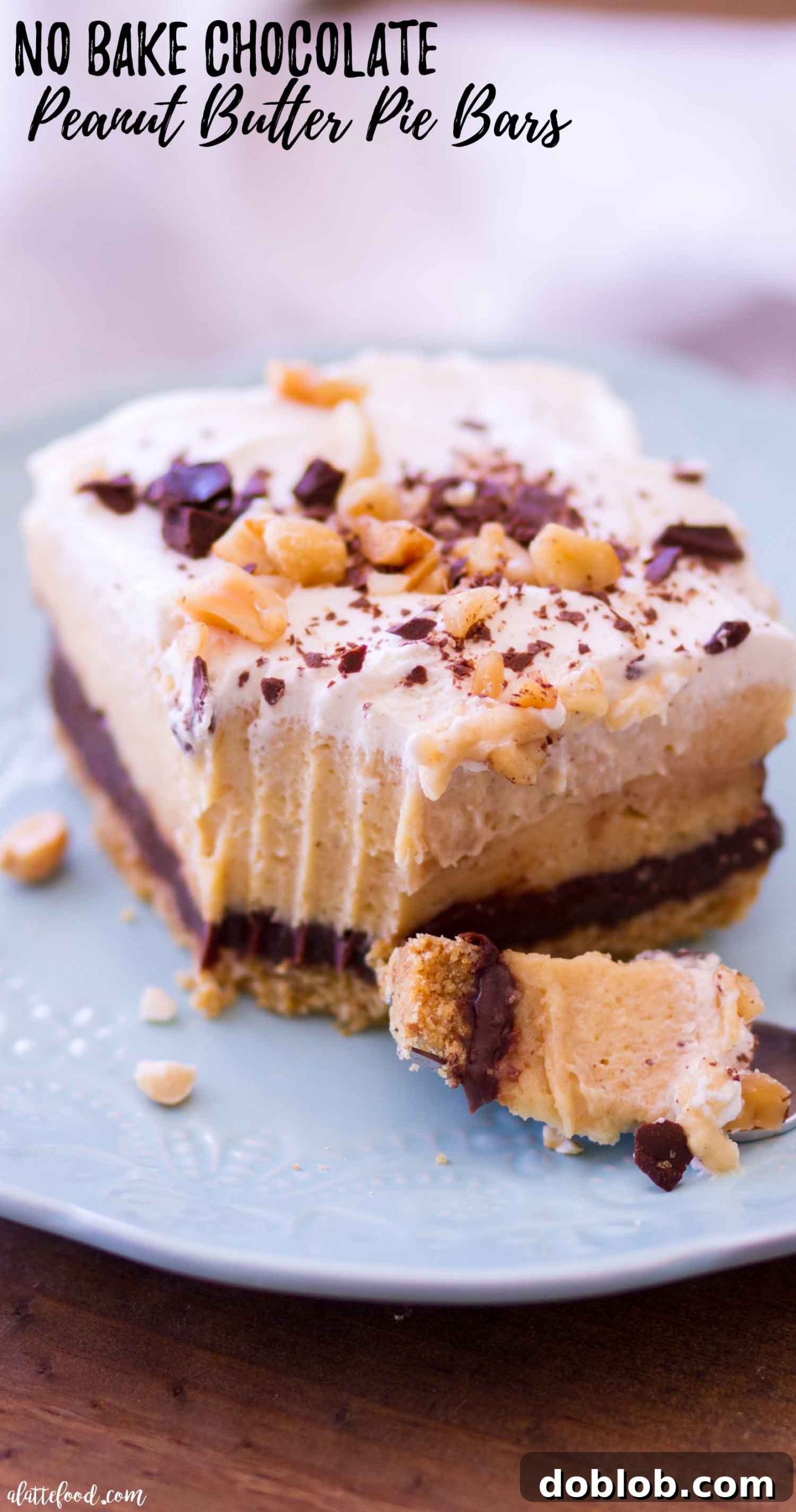 A no-bake chocolate peanut butter pie bar with a bite taken out, revealing the creamy texture inside.