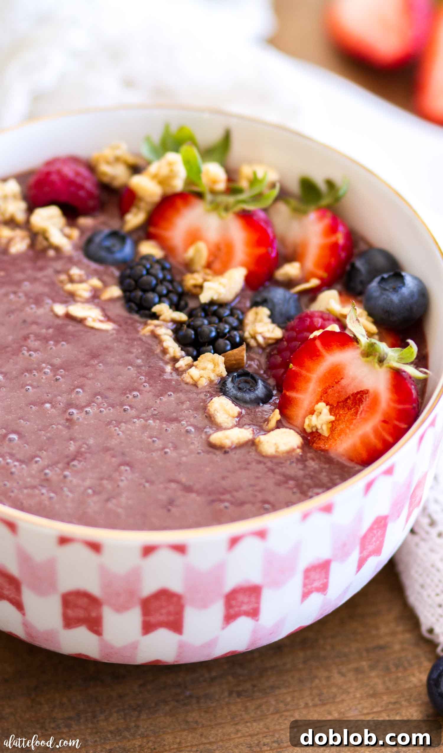 Classic Açaí bowl, brimming with a rich purple base and generously topped with an assortment of fresh berries including whole blueberries and sliced strawberries, along with a sprinkle of chia seeds, creating a visually appealing and healthy meal. Keywords: classic Acai bowl, fresh berries, healthy breakfast, superfood, easy recipe, gluten free, refined sugar free.