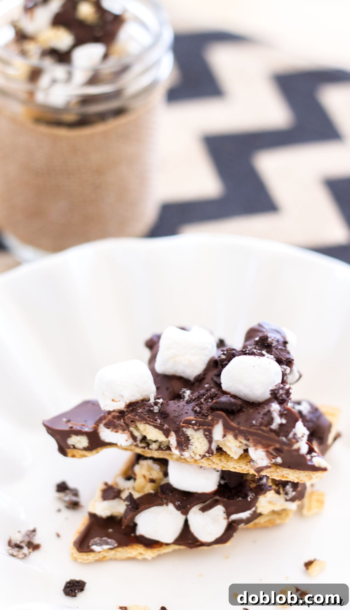 Layered S'mores Oreo Bark, showcasing graham crackers, melted chocolate, and a generous topping of Oreos and marshmallows.