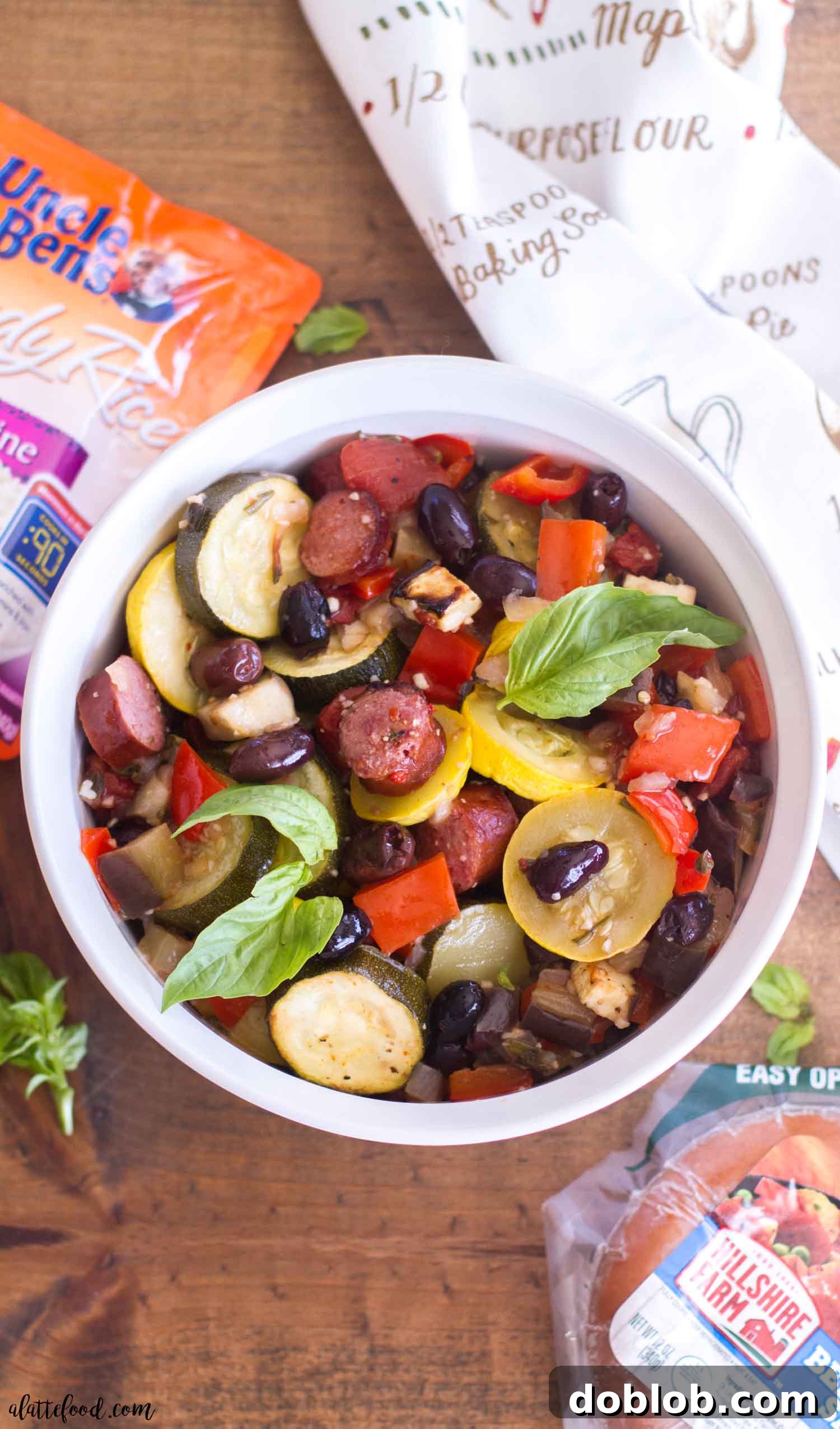 Wholesome Roasted Ratatouille with Hillshire Farm Smoked Sausage Overhead view of a delicious Roasted Ratatouille Bowl with golden-brown smoked sausage and an assortment of freshly roasted vegetables, embodying a wholesome and quick dinner idea.