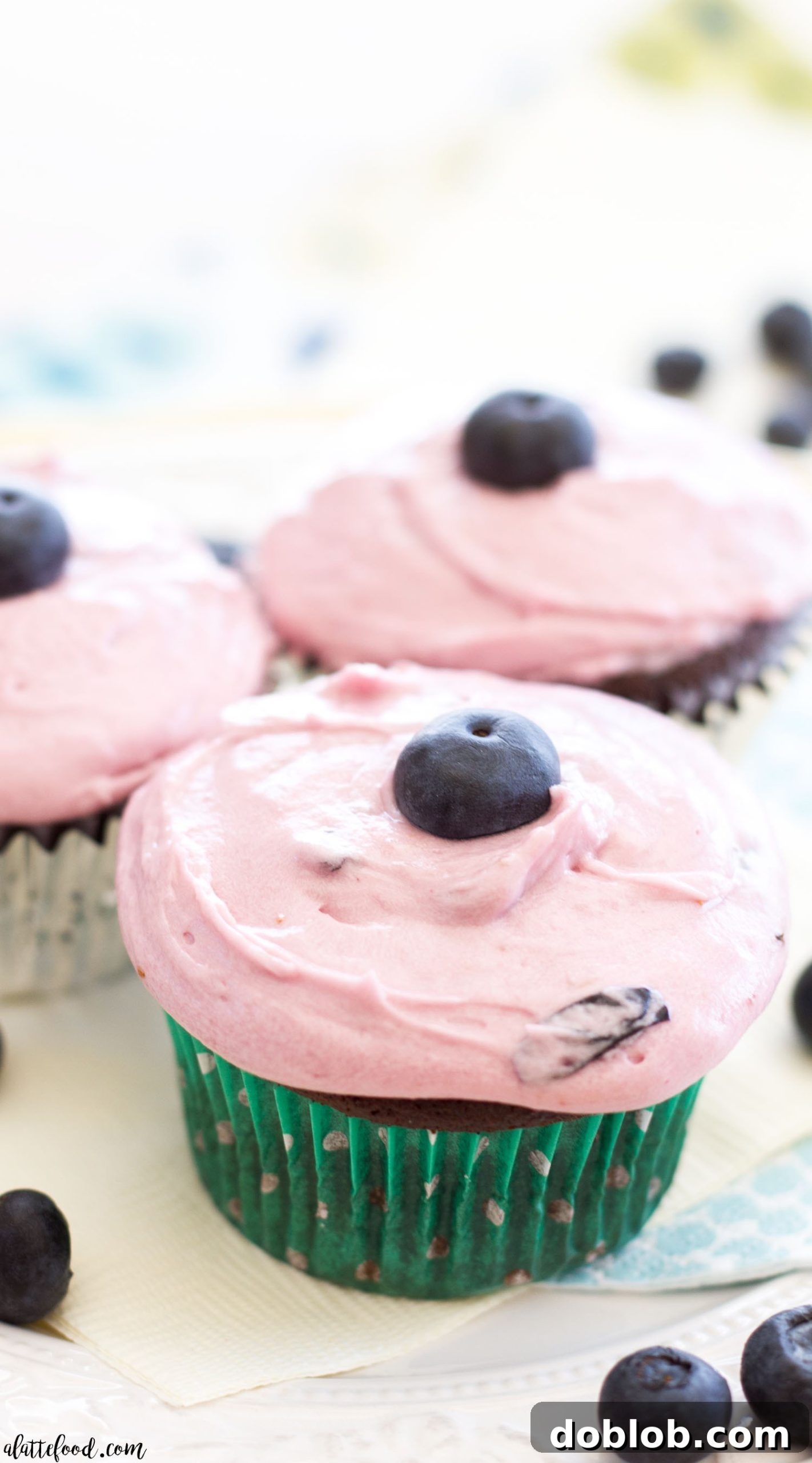 Rich milk chocolate cupcakes with swirl of purple blueberry frosting