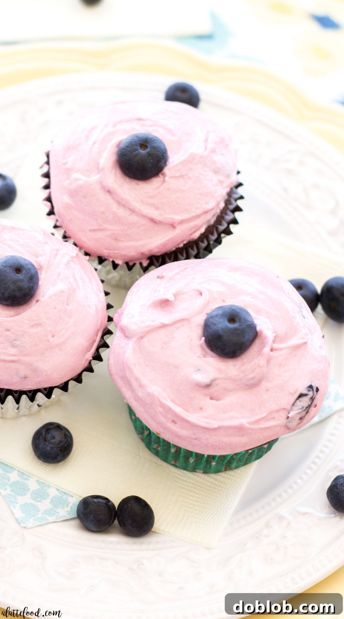 Close-up of a homemade milk chocolate cupcake with fresh blueberry frosting
