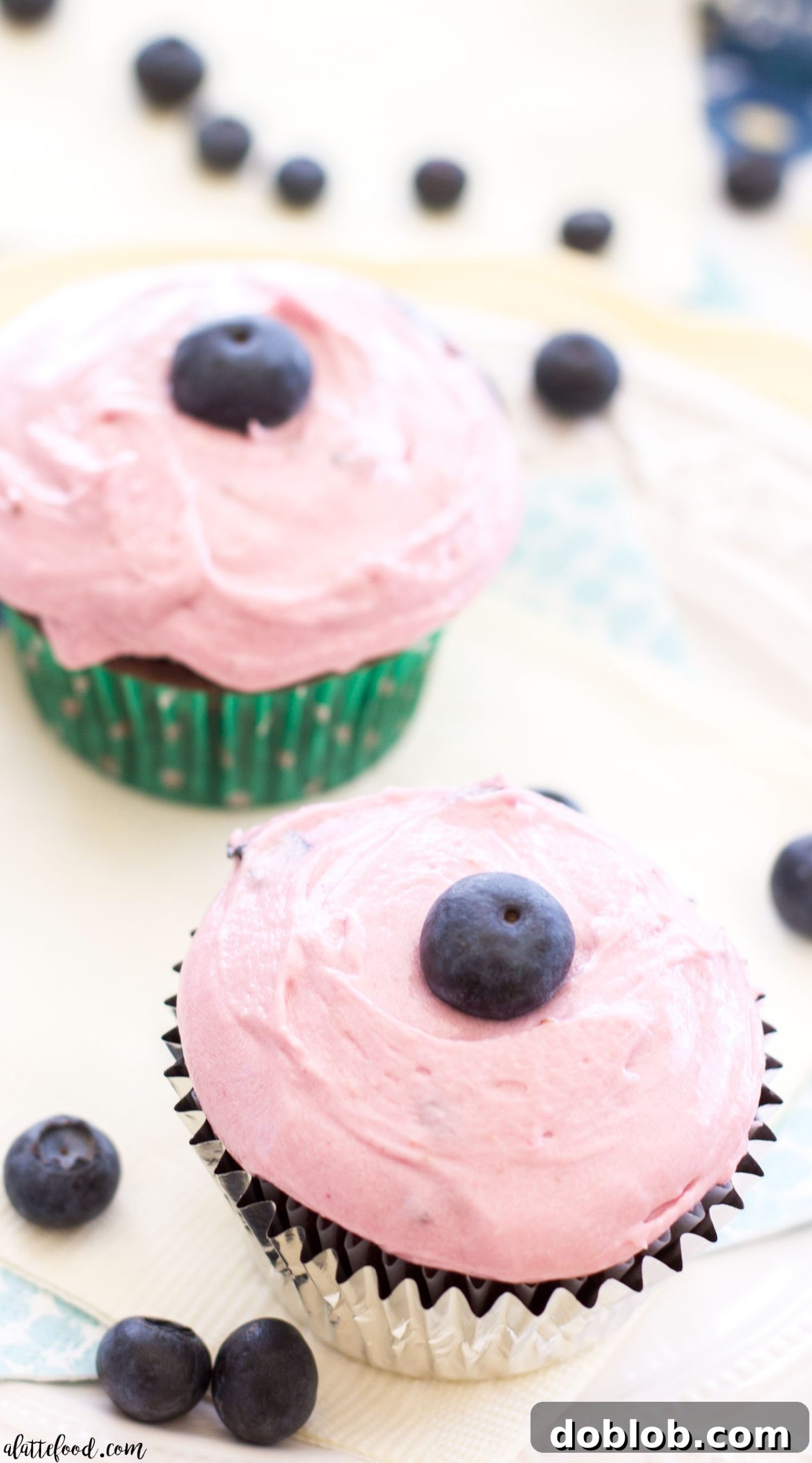 Several milk chocolate cupcakes with blueberry frosting ready to be eaten