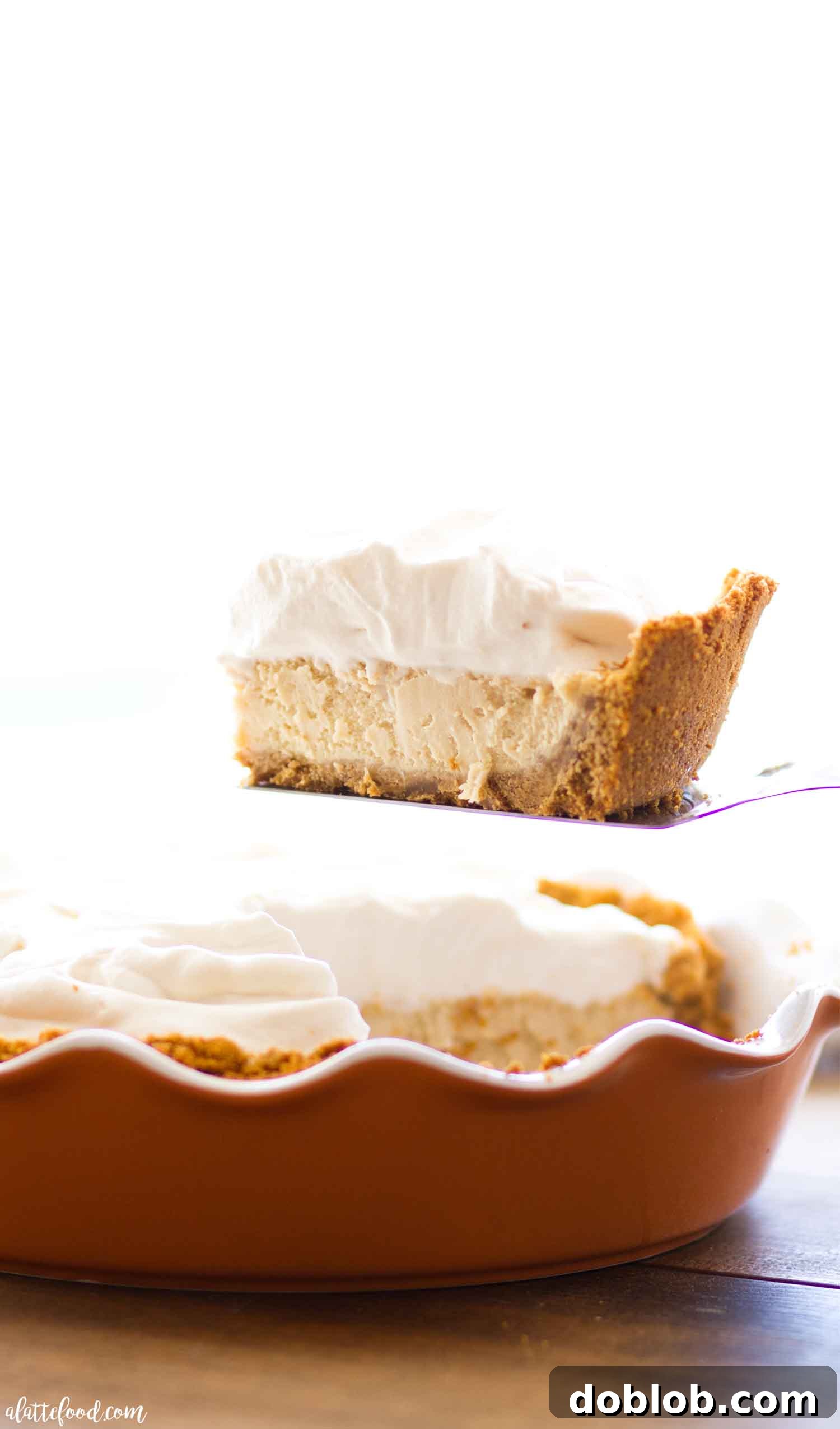 A beautifully set Homemade Caramel Cheesecake, featuring a rustic pecan graham cracker crust and topped with fluffy caramel whipped cream.